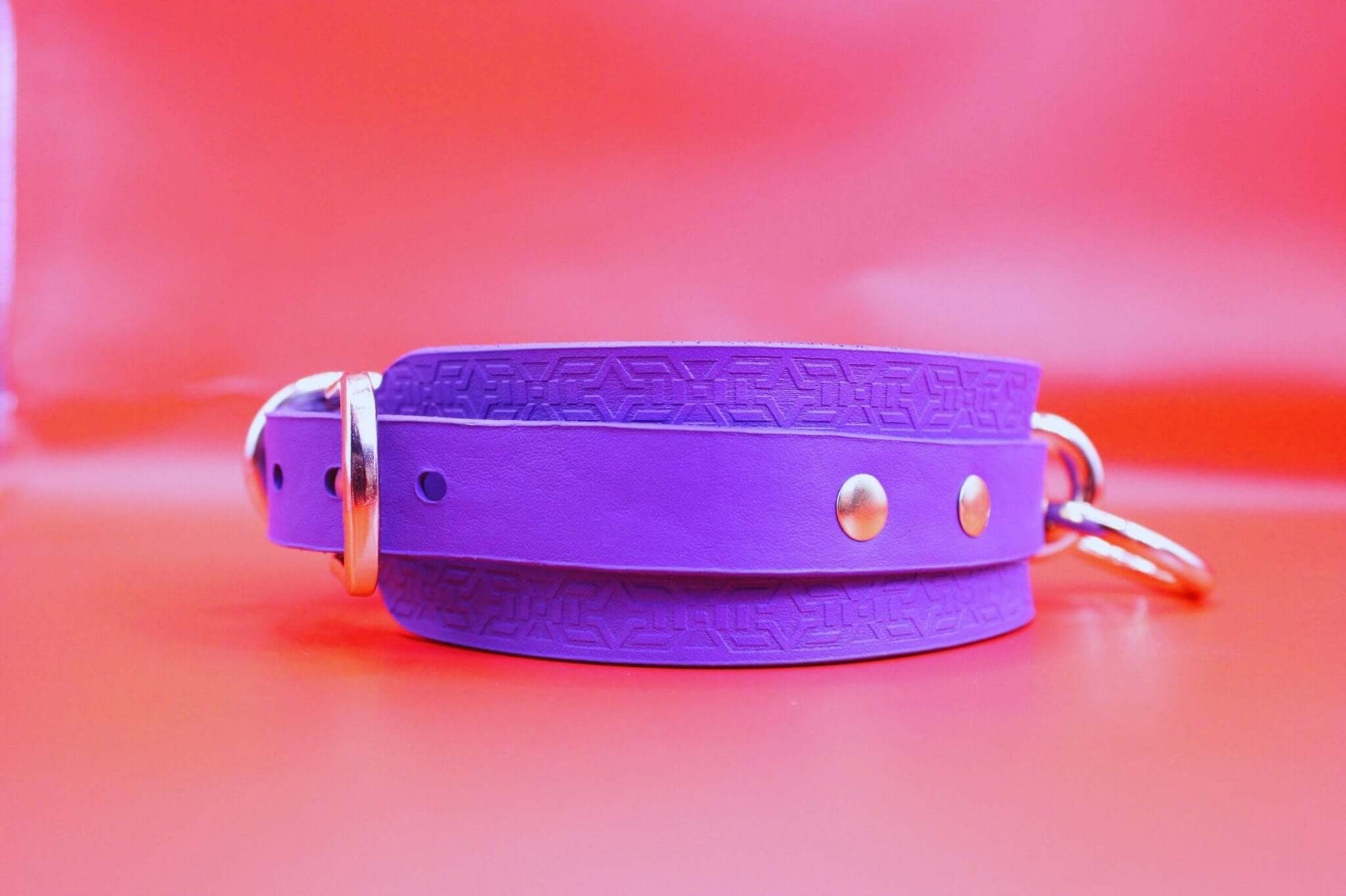 Vibrant violet leather choker collar, perfect for BDSM, discreet day wear, and submissive jewelry.