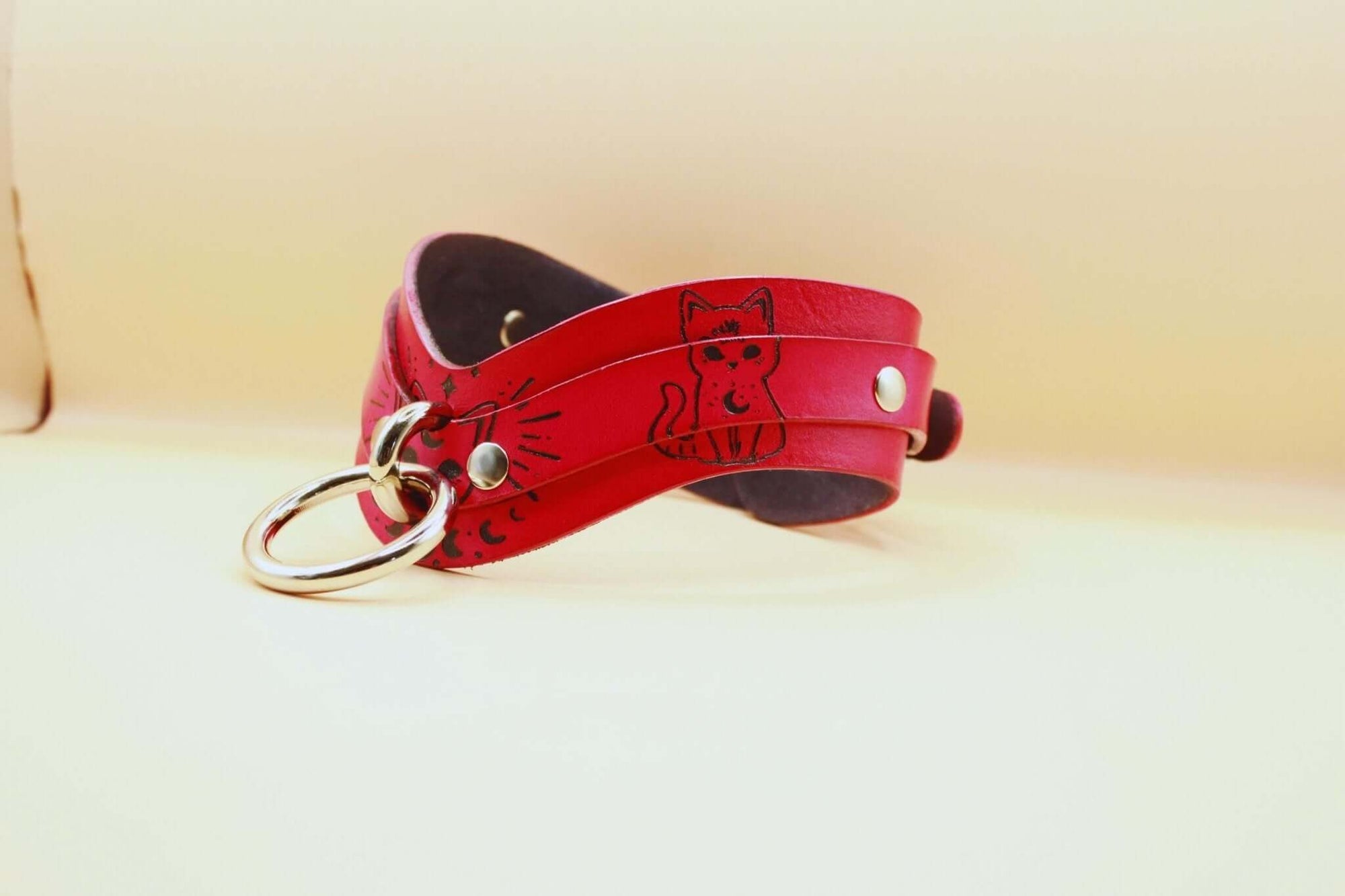 Elegant leather submissive day collar with cat motifs, perfect for BDSM play or discreet everyday wear.
