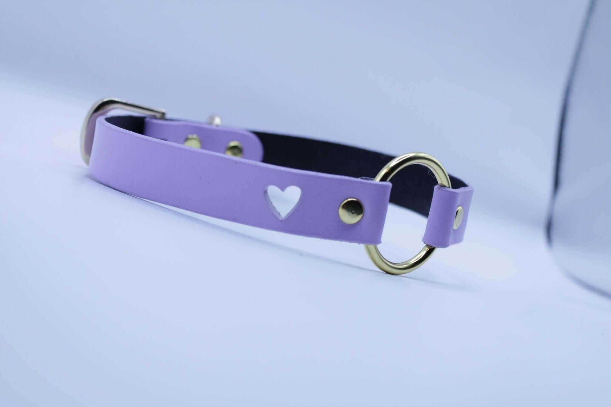 Lilac BDSM collar with heart cutout and gold O-ring, perfect for submissive jewelry and discreet day collar fashion.