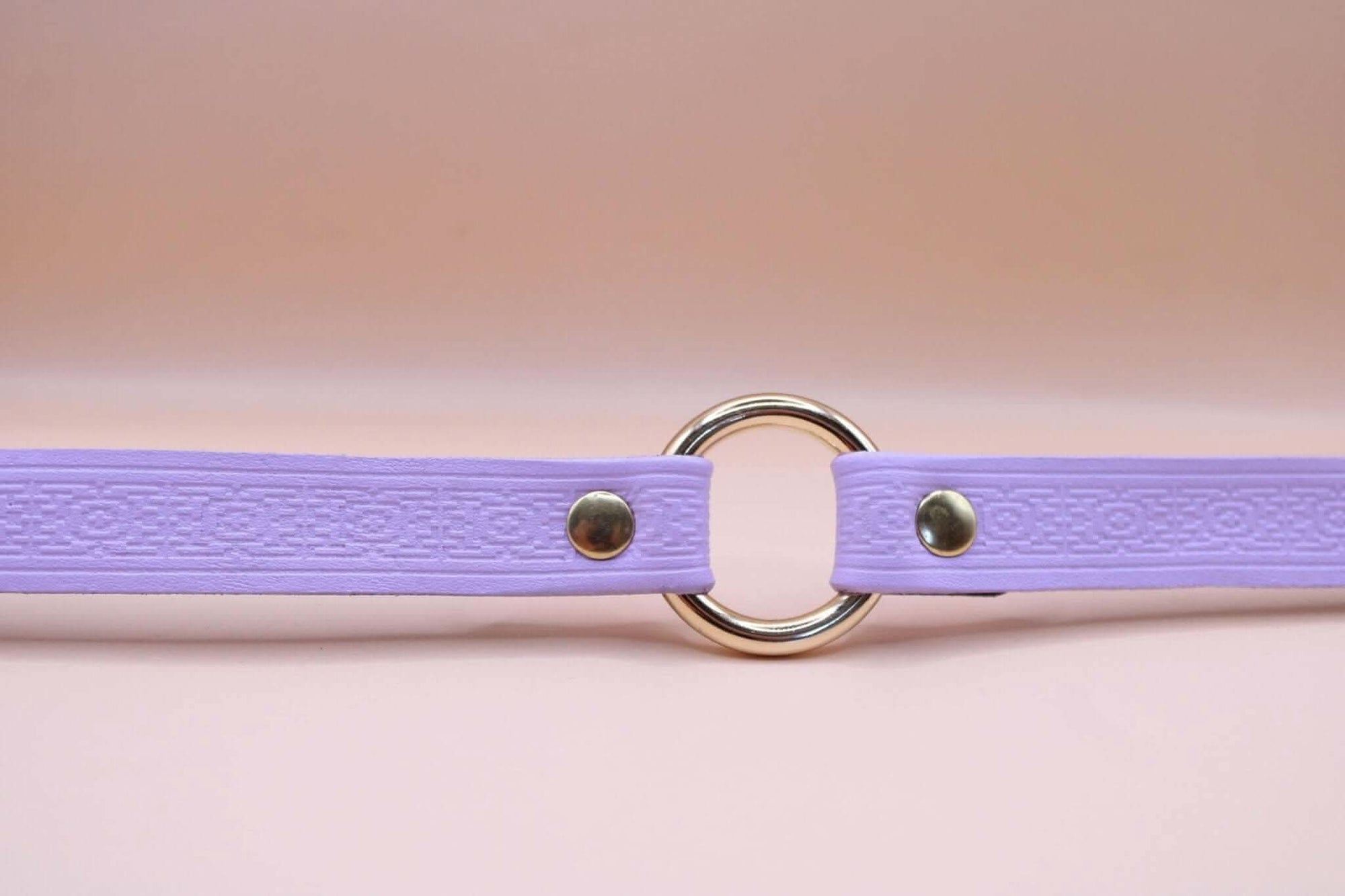 Lilac handmade submissive collar with embossed pattern, perfect for discreet day wear in BDSM settings.