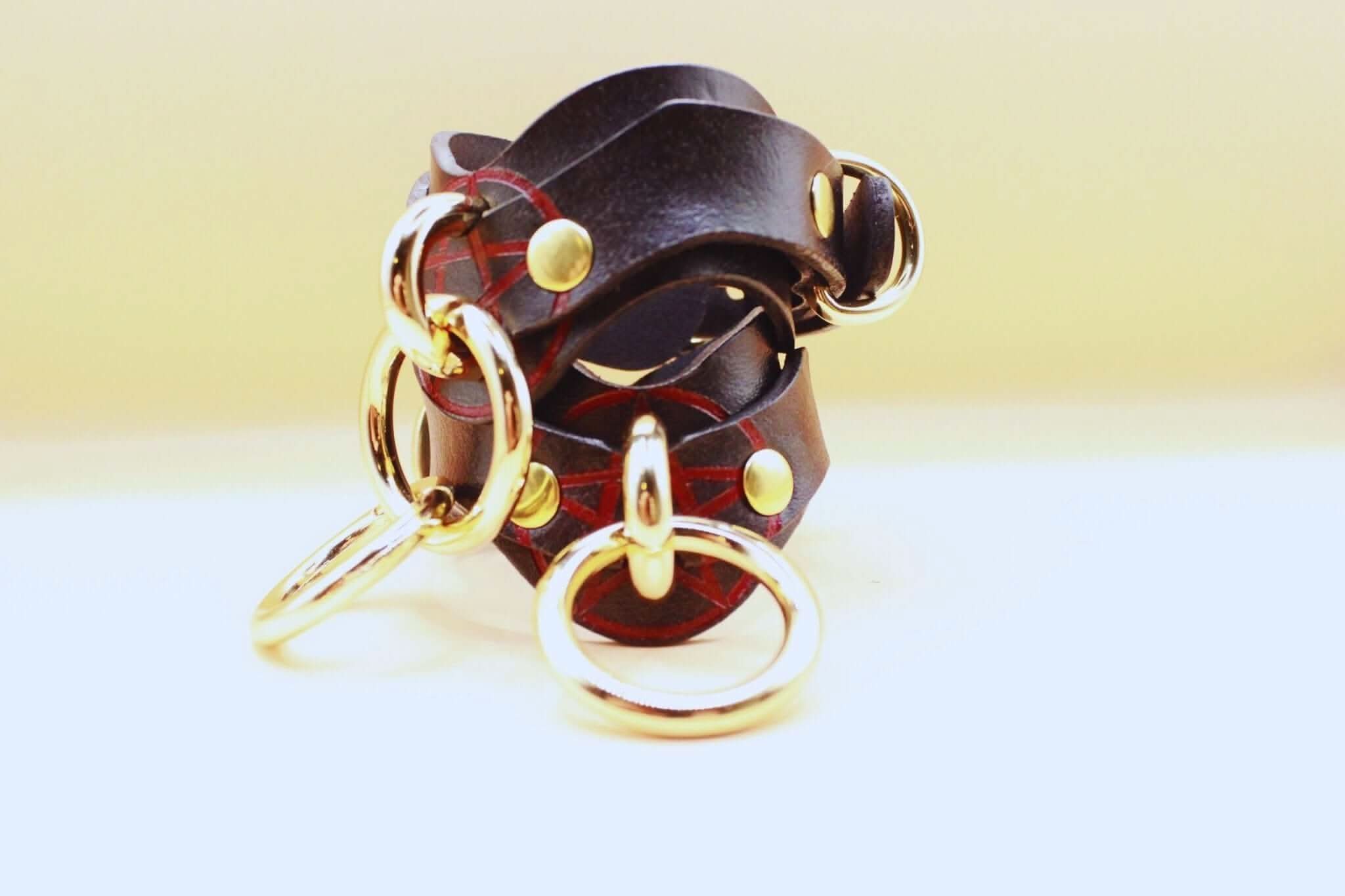 Luxury leather BDSM cuffs with gold hardware, ideal for bondage play and styled for submissives and dominants.