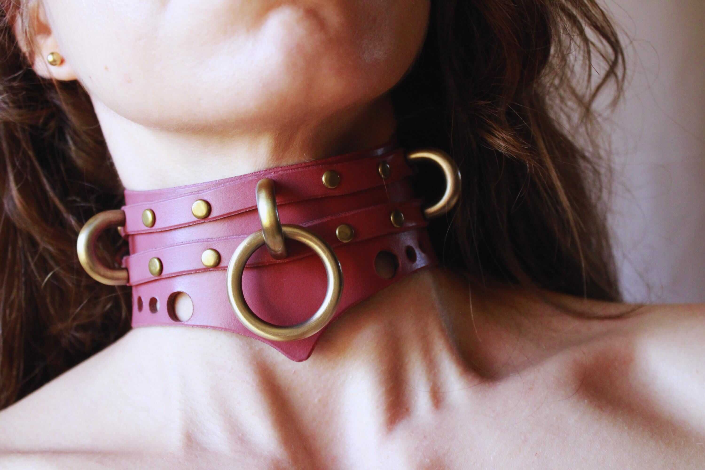 Mauve leather posture collar with gold accents, perfect for BDSM jewelry and discreet submissive day wear.