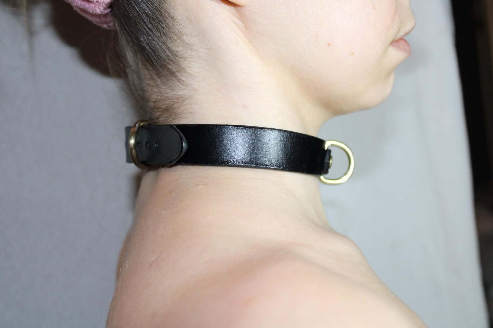 Minimalist black leather choker collar showcasing a discreet submissive jewelry piece for everyday elegance.