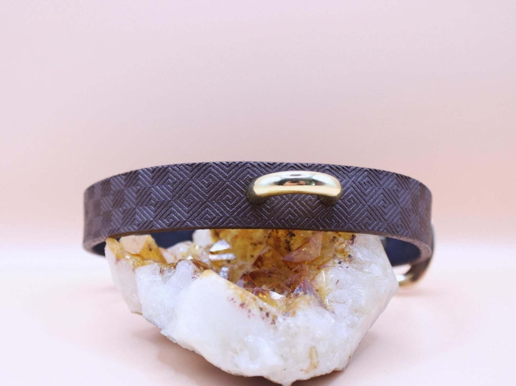 Minimalist dark brown leather submissive collar with gold accent, perfect for discreet BDSM and elegant bondage jewelry.