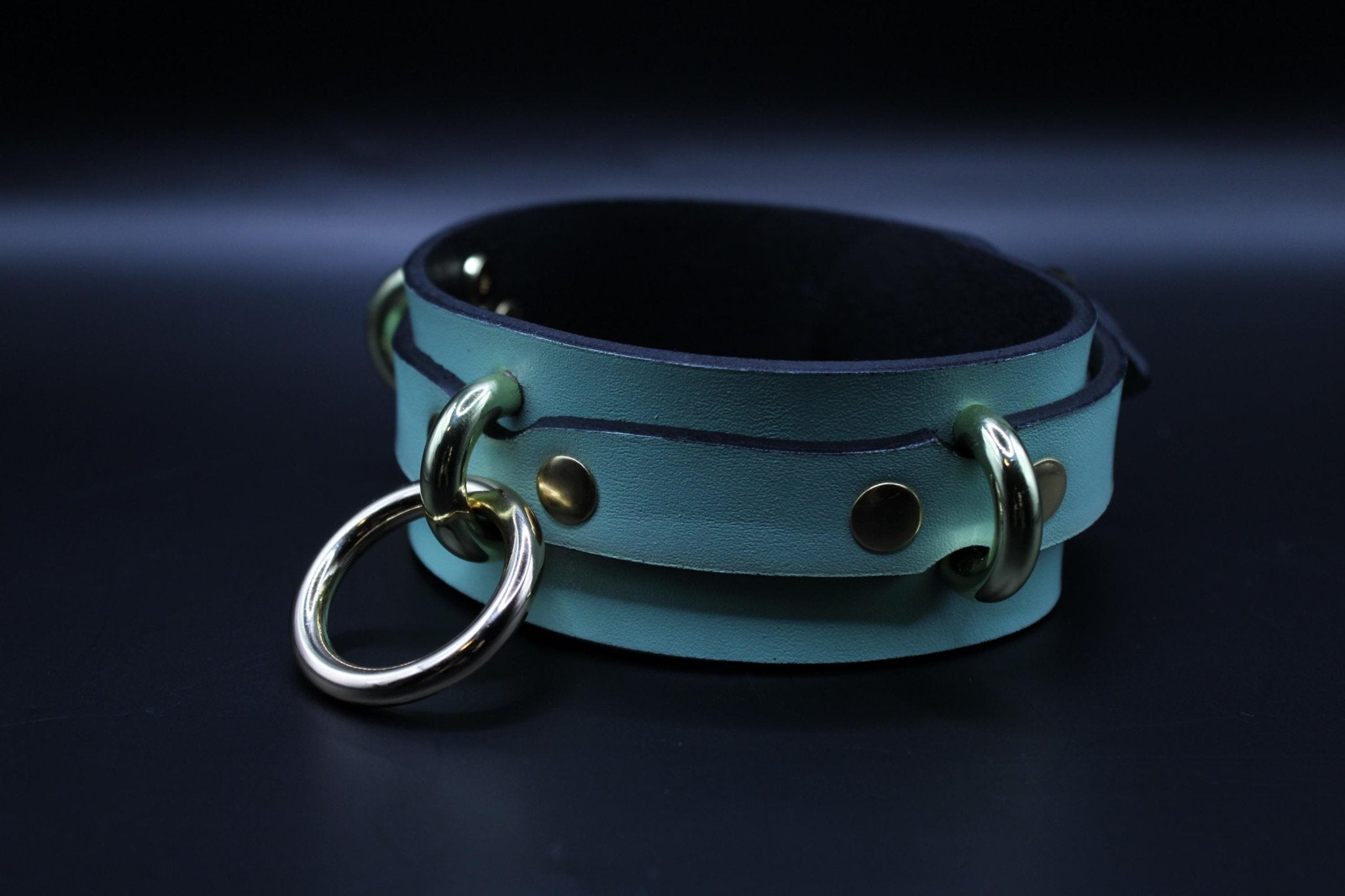Mint green BDSM collar with gold accents, designed for submissive play and bondage gear.