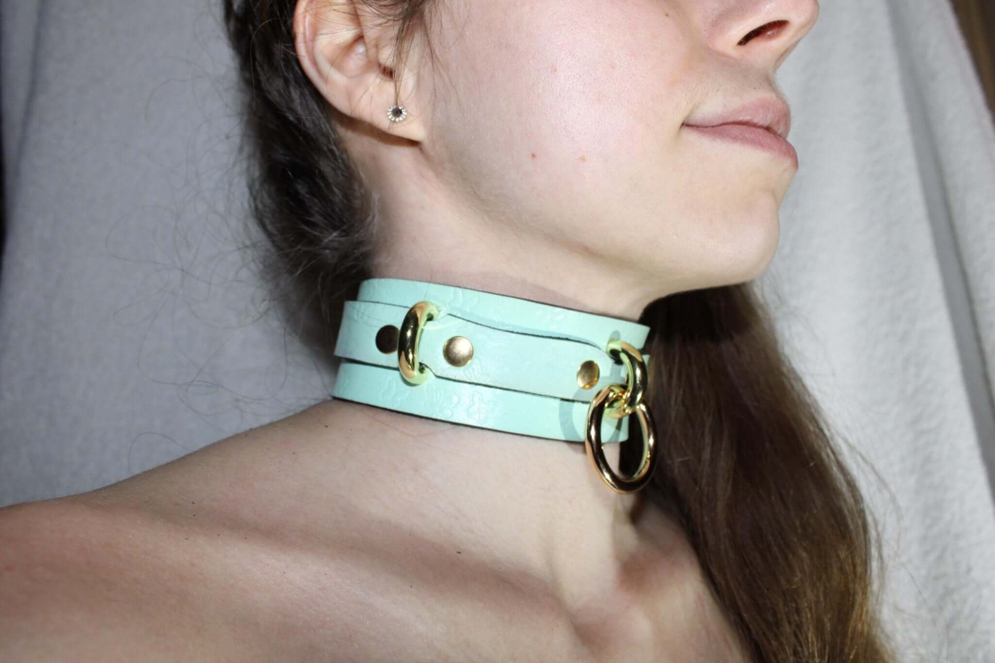 Mint green leather submissive collar with gold hardware, perfect for BDSM and bondage play.