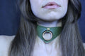 Olive green posture collar with bold O-ring, perfect for submissive jewelry and bondage aesthetics.
