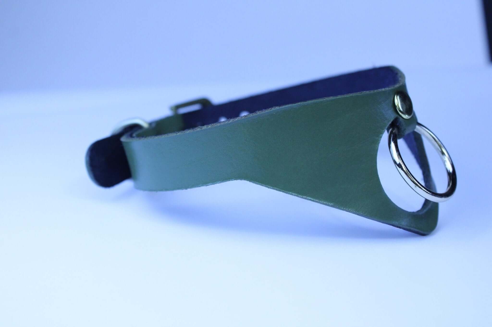Olive green posture collar with bold O-ring, ideal for submissive jewelry and BDSM day collar aesthetics.