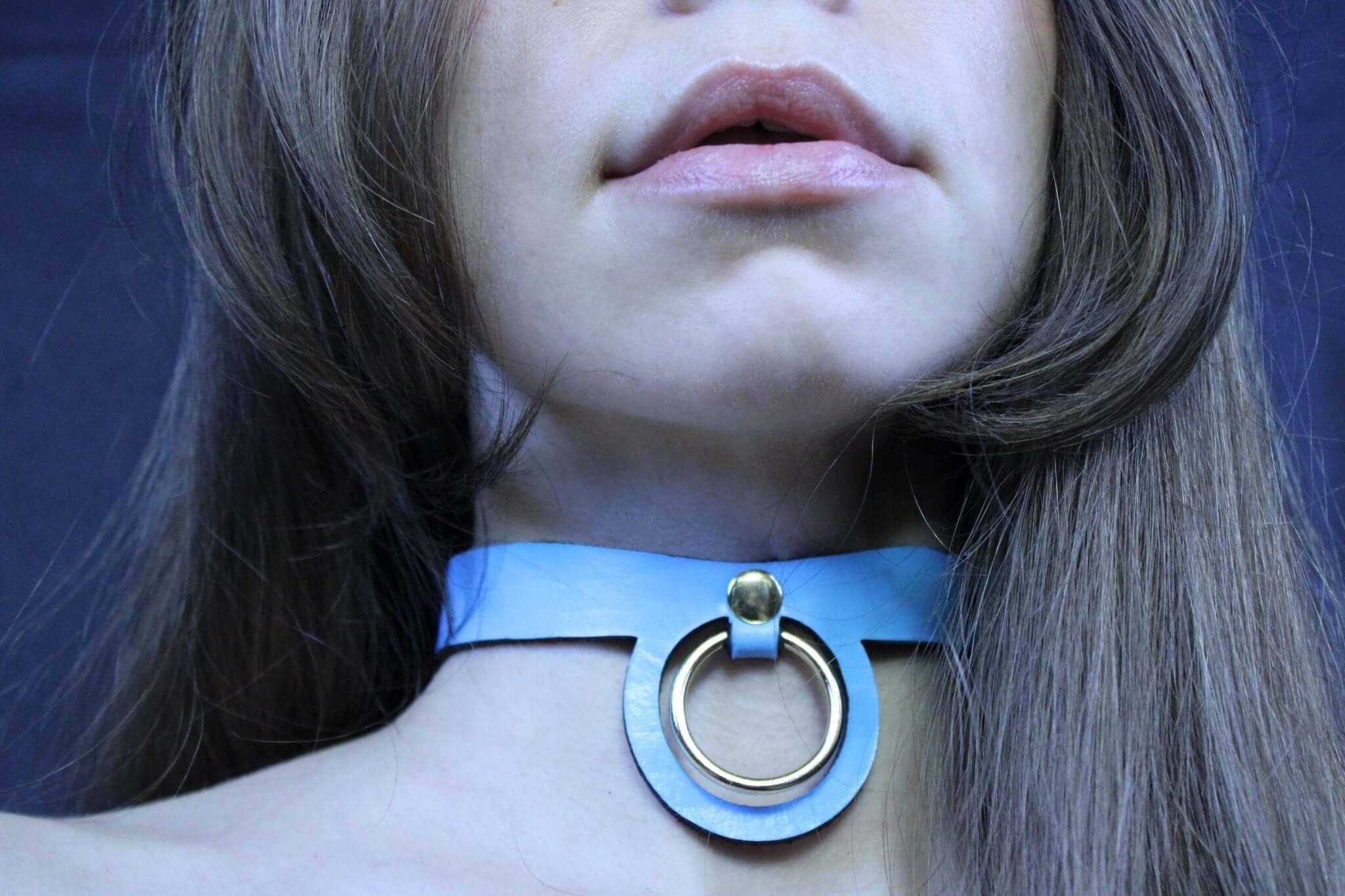 Pastel blue submissive collar featuring a golden ring, ideal for BDSM and discreet day wear.