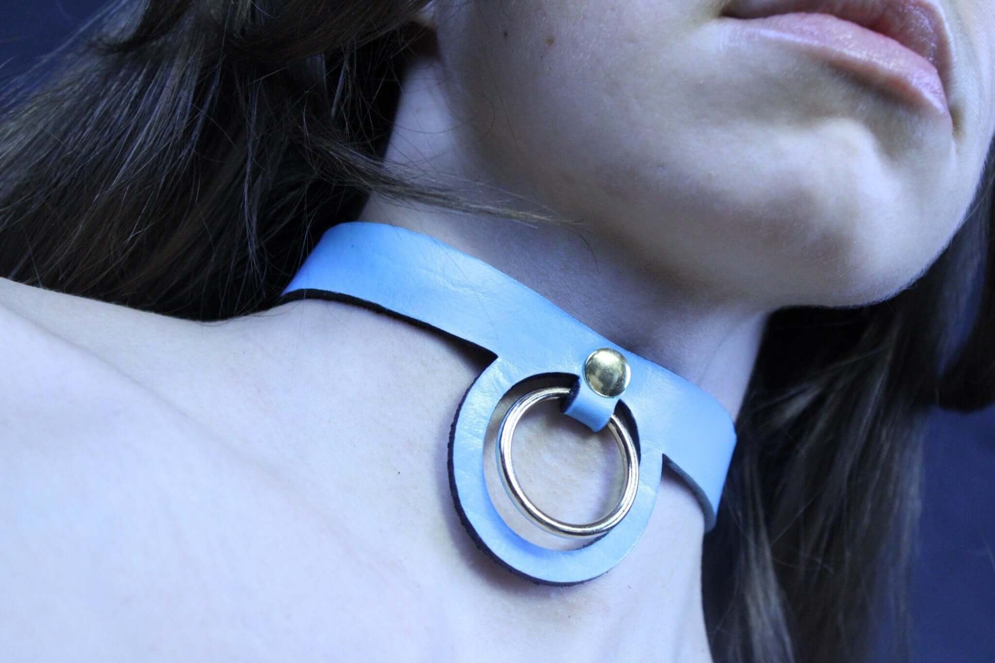 Pastel blue BDSM collar featuring a gold ring, perfect for submissive jewelry and discreet day wear.