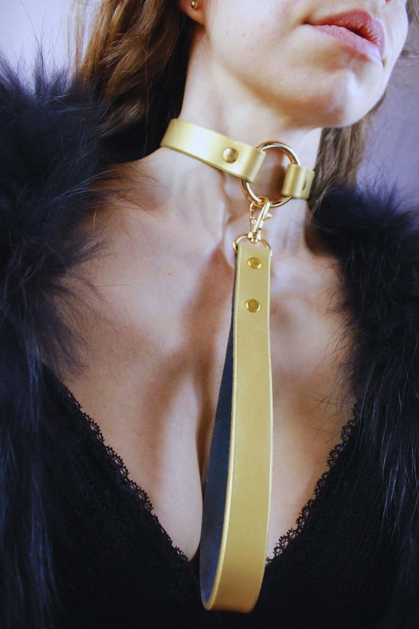 Elegant gold leather submissive collar for discreet day wear, blending BDSM fashion with sensuality.