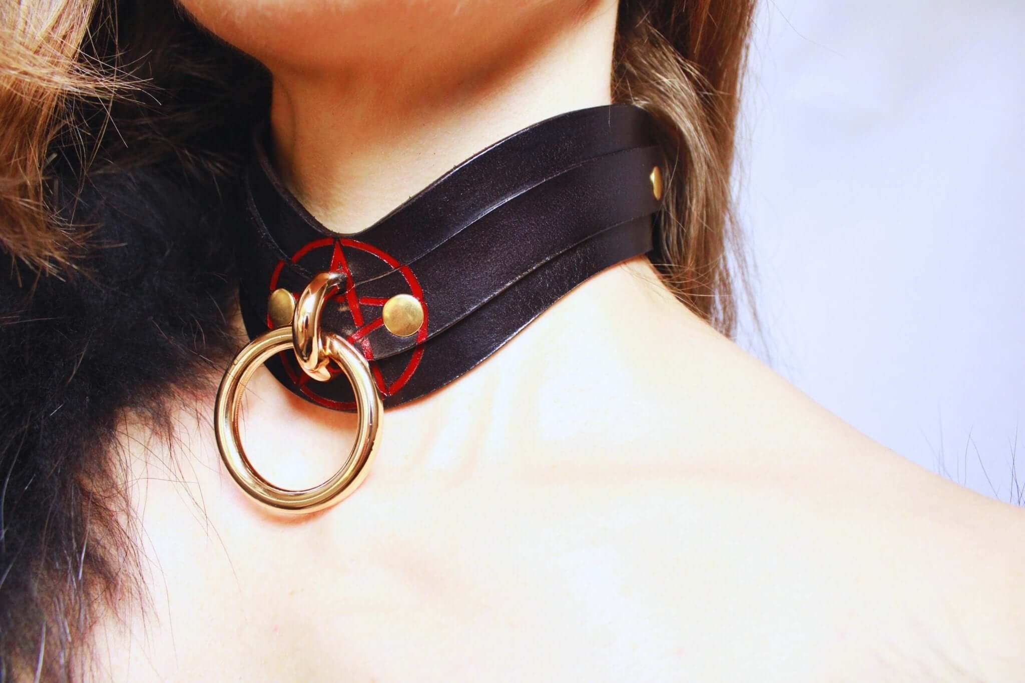 Luxurious black leather BDSM collar with pentagram and gold ring, ideal for bondage and submissive jewelry.