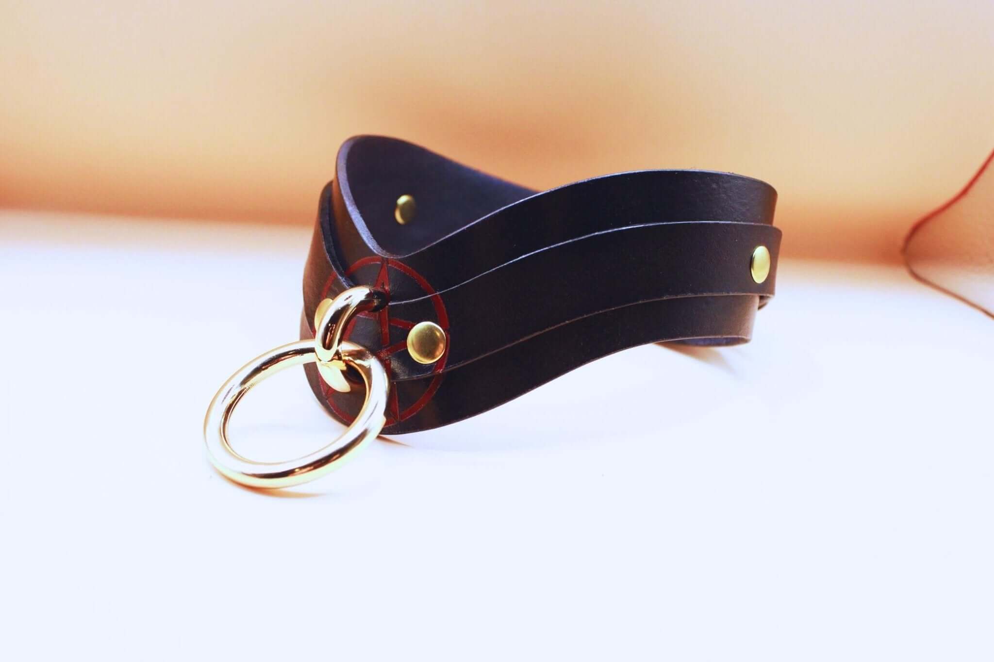 Elegant black leather BDSM collar featuring gold hardware, perfect as a discreet day collar or submissive jewelry.