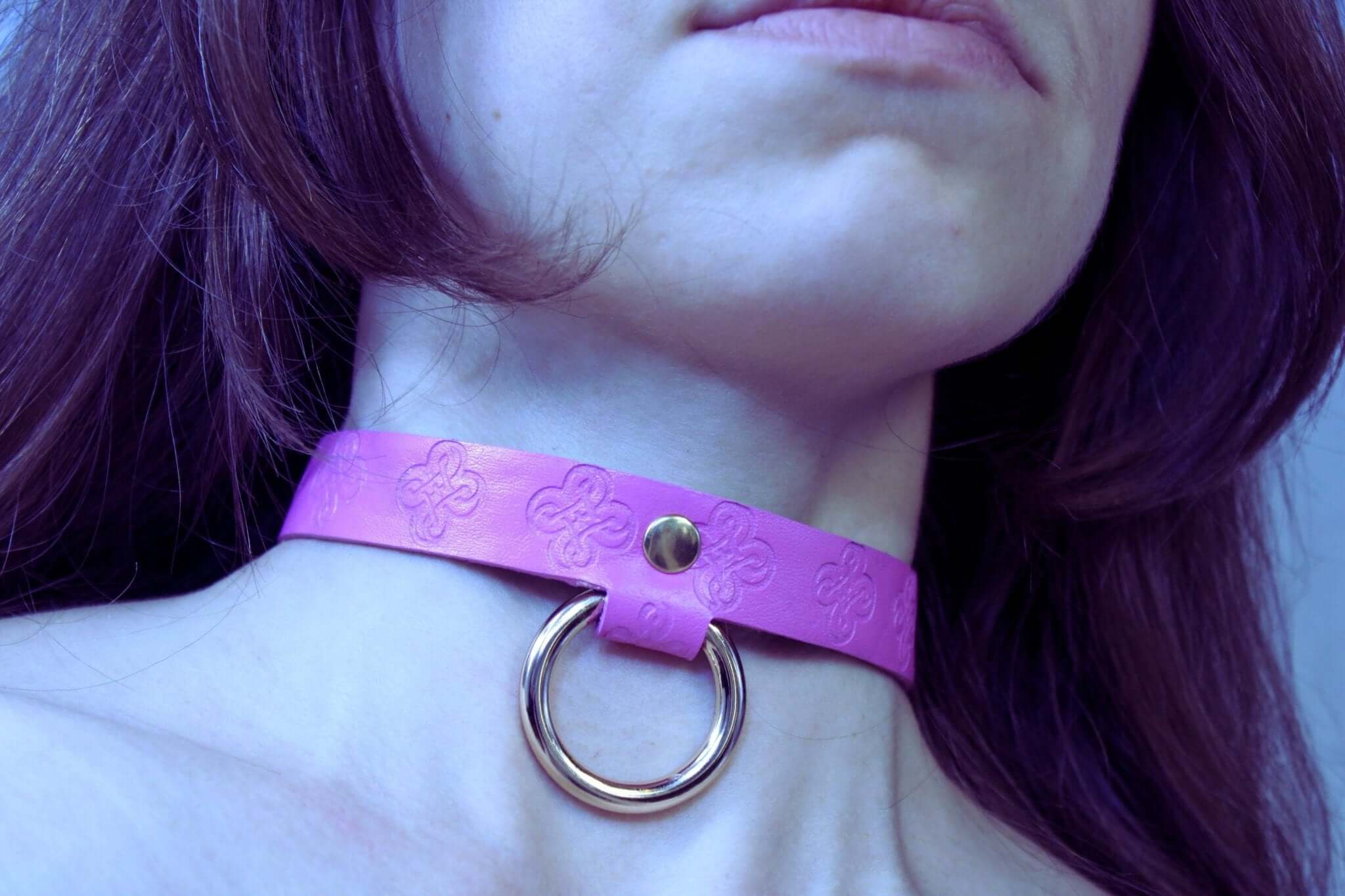 Pink leather BDSM collar with O-ring for submissive wear, perfect as a discreet day collar or bondage accessory.