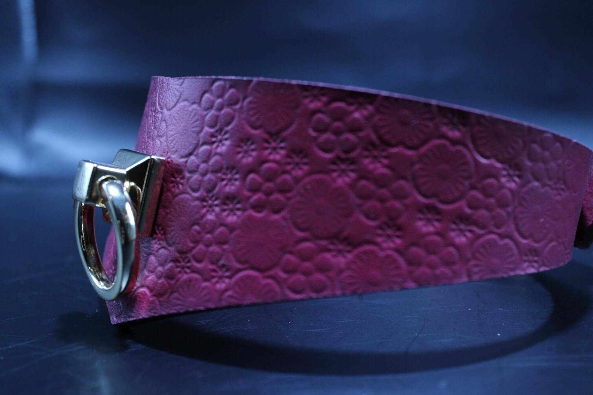 Handmade pink leather submissive collar with golden O-ring, perfect for BDSM and petplay; a stylish bondage accessory.