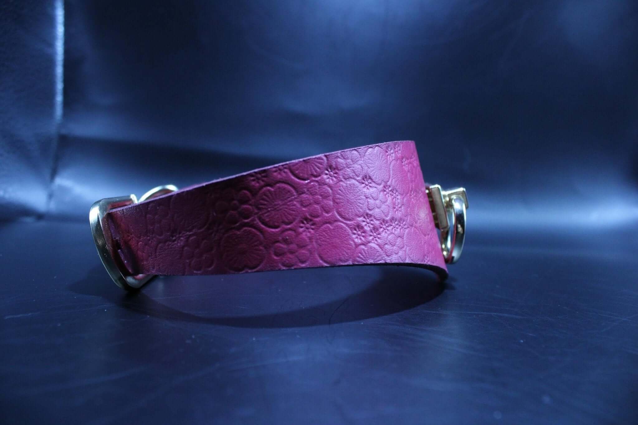 Pink leather submissive collar with gold hardware, designed for bondage and discreet day wear in BDSM play.