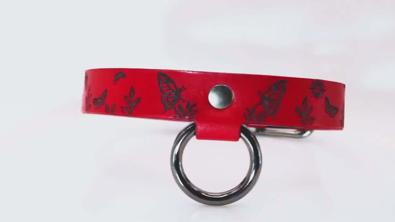 Submissive collar in deep red leather with butterfly designs, perfect for BDSM collar and everyday wear.
