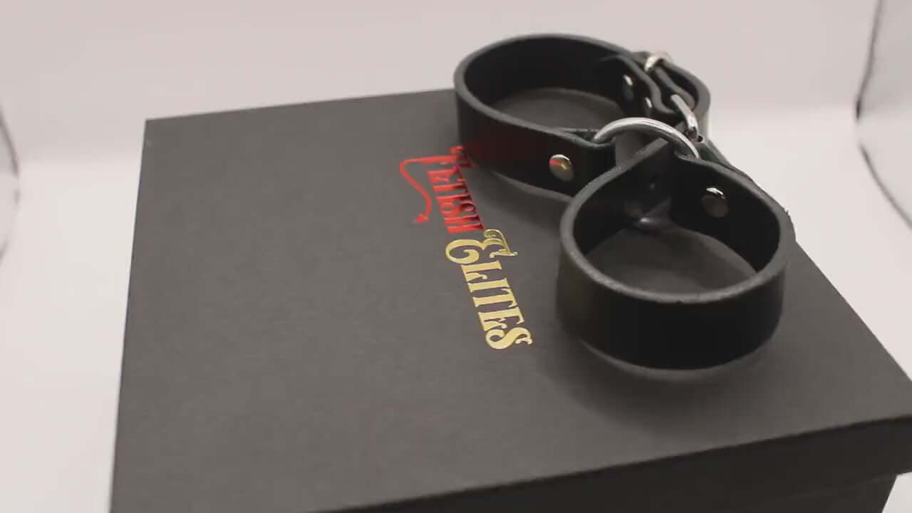 Leather handcuffs displayed with packaging, perfect for BDSM play and enhancing trust in intimate relationships.