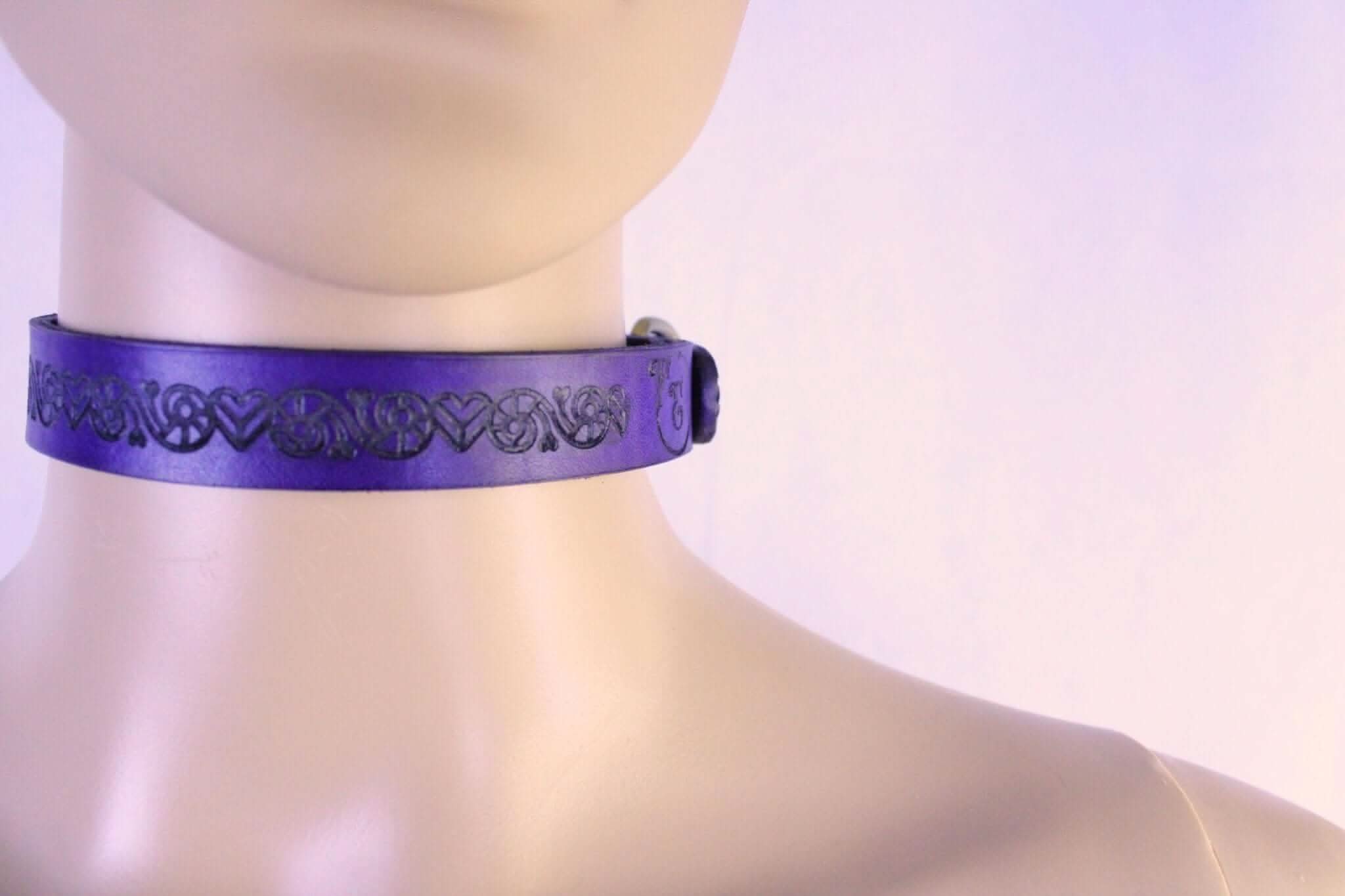 Purple leather BDSM sub collar adorned with heart designs, perfect for discreet elegance in submissive jewelry.