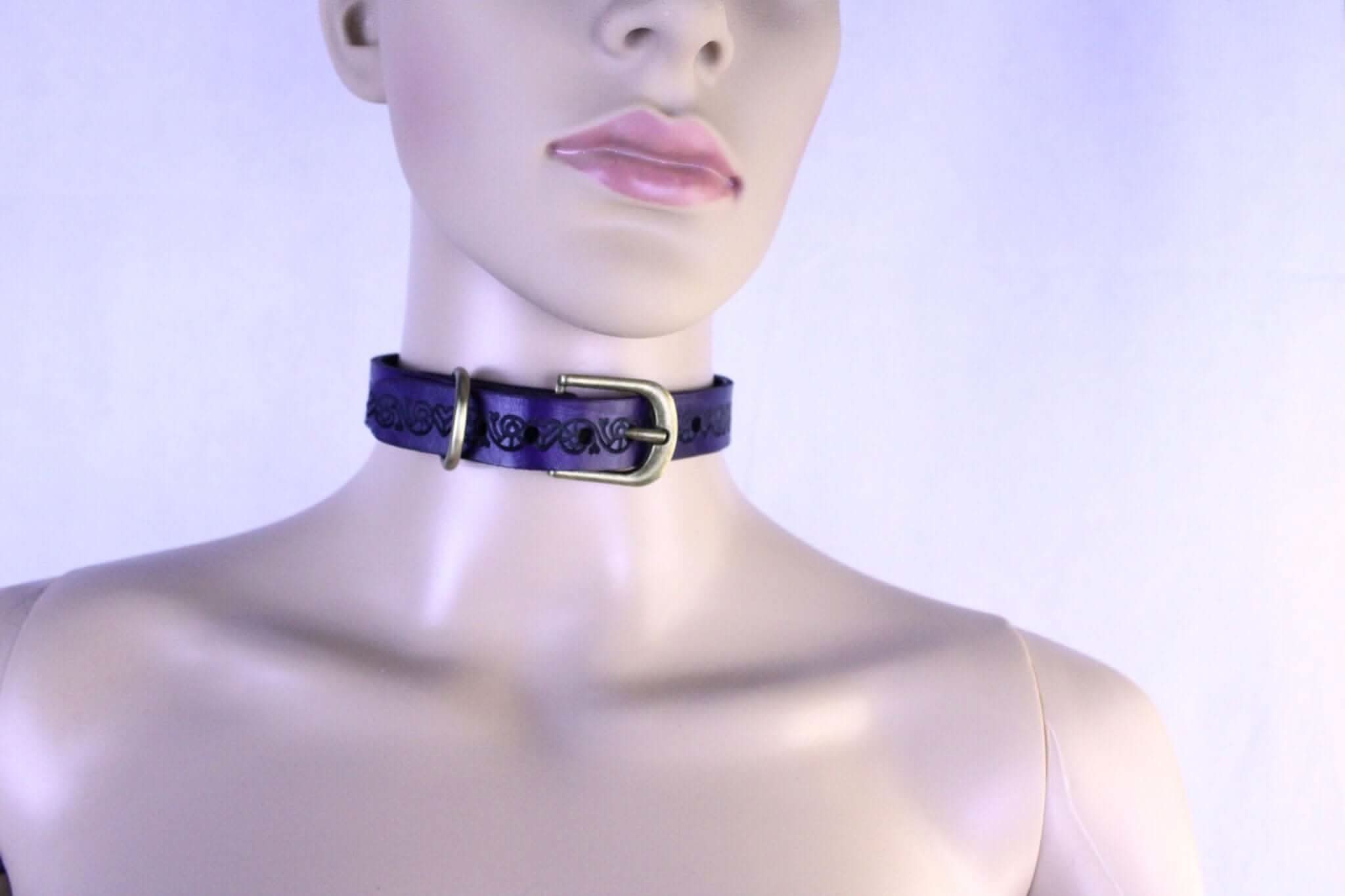 Purple leather BDSM collar on mannequin, perfect for discreet submission and stylish erotic jewelry.