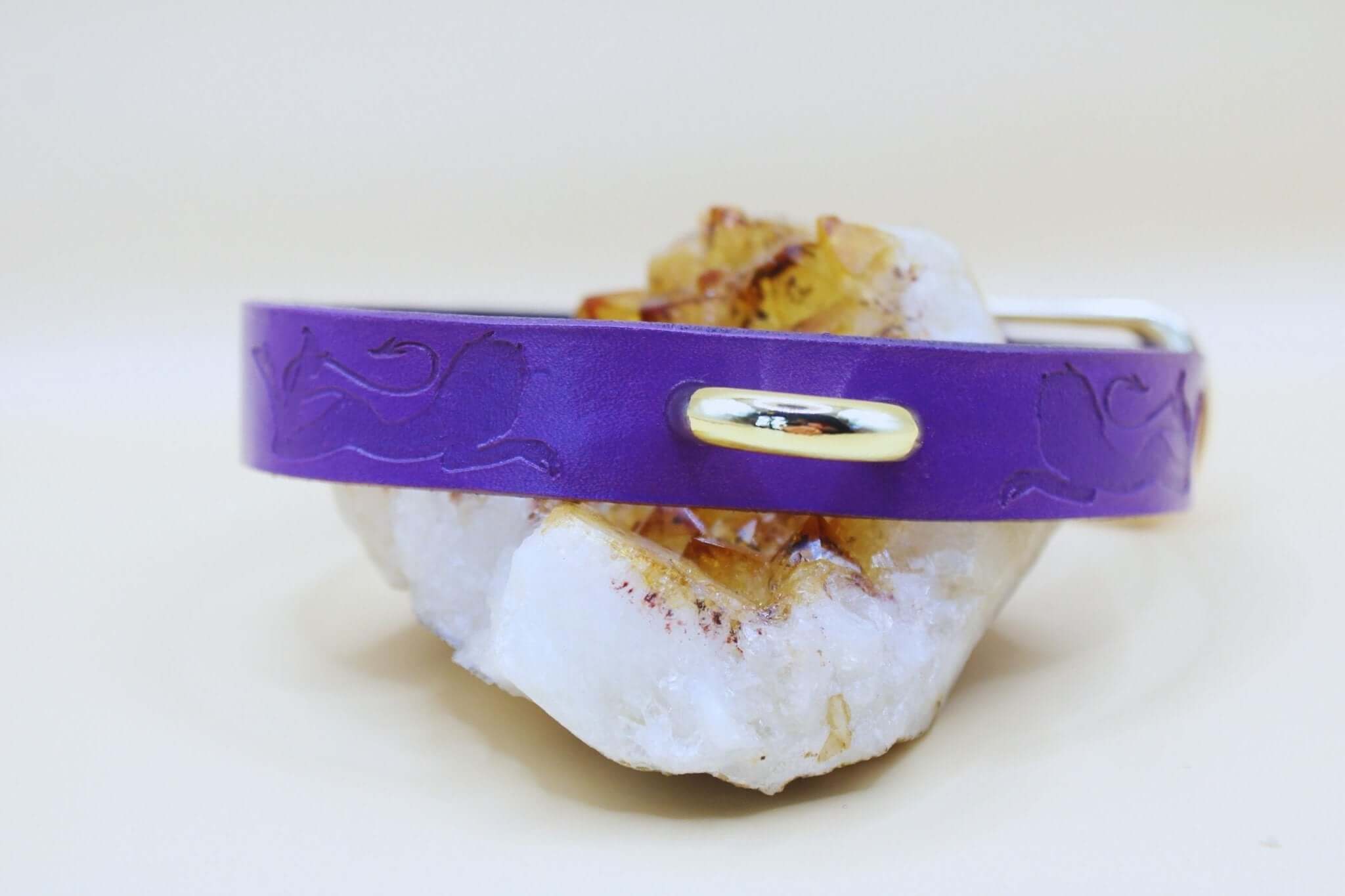 Elegant purple submissive collar showcasing BDSM jewelry on a crystal base, symbolizing trust and empowerment.