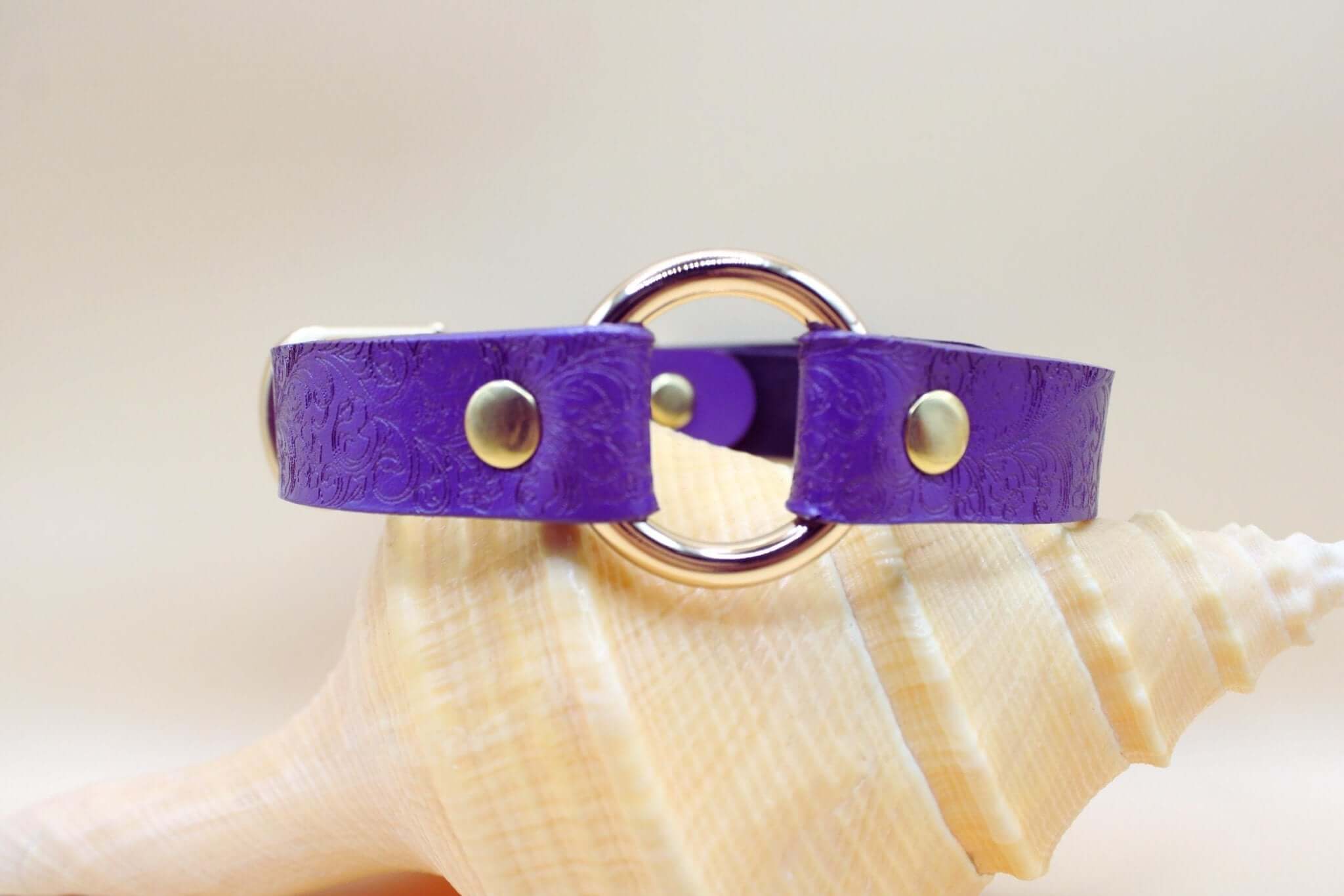 Handcrafted purple leather BDSM collar with embossed floral design and O-ring, perfect for submissive jewelry and bondage gear.