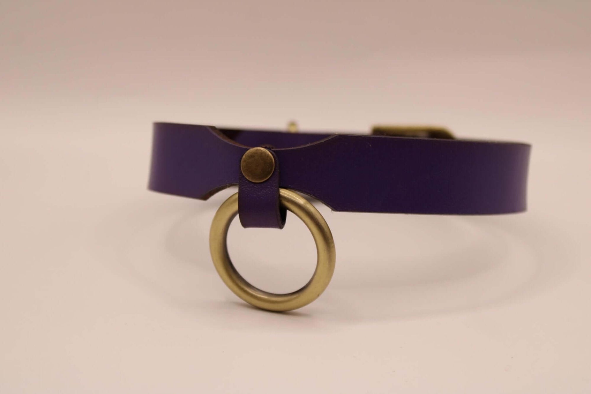 Purple leather submissive collar with metal ring, perfect for BDSM and sensual aesthetics.