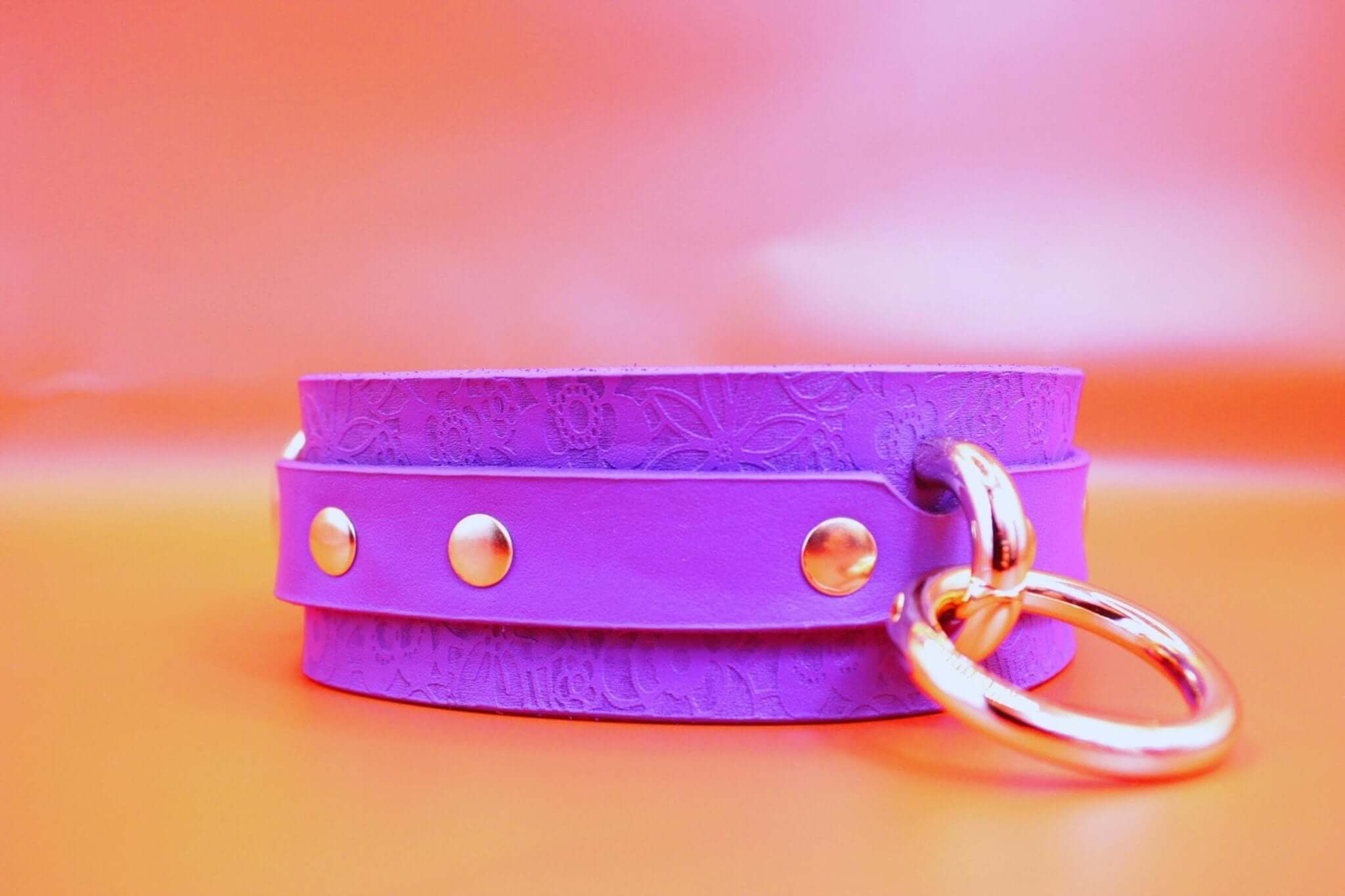 Elegant purple leather choker collar with gold accents, perfect for BDSM, discreet day wear, and submissive jewelry.