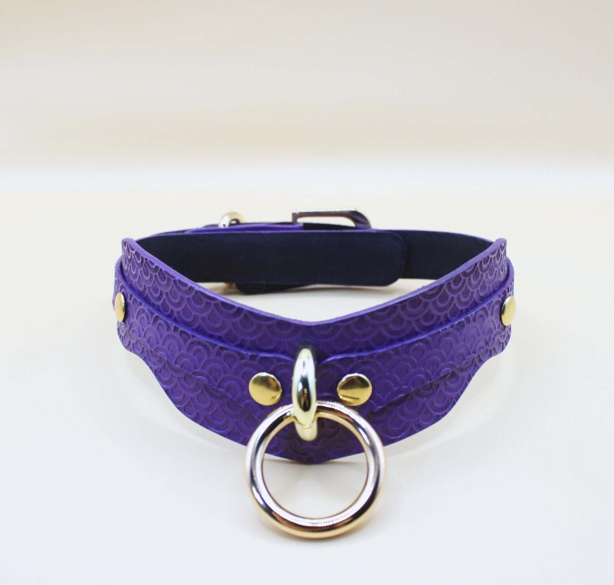 Purple BDSM collar with D-ring, embossed design, perfect for submissive jewelry and bondage gear.
