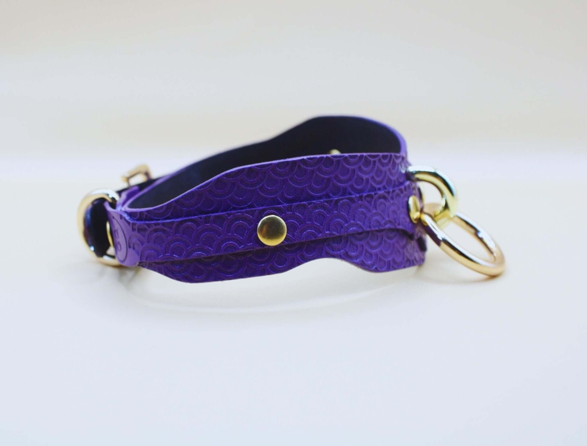 Elegant deep purple BDSM collar with embossed pattern and D-ring, perfect for submissive jewelry and bondage play.