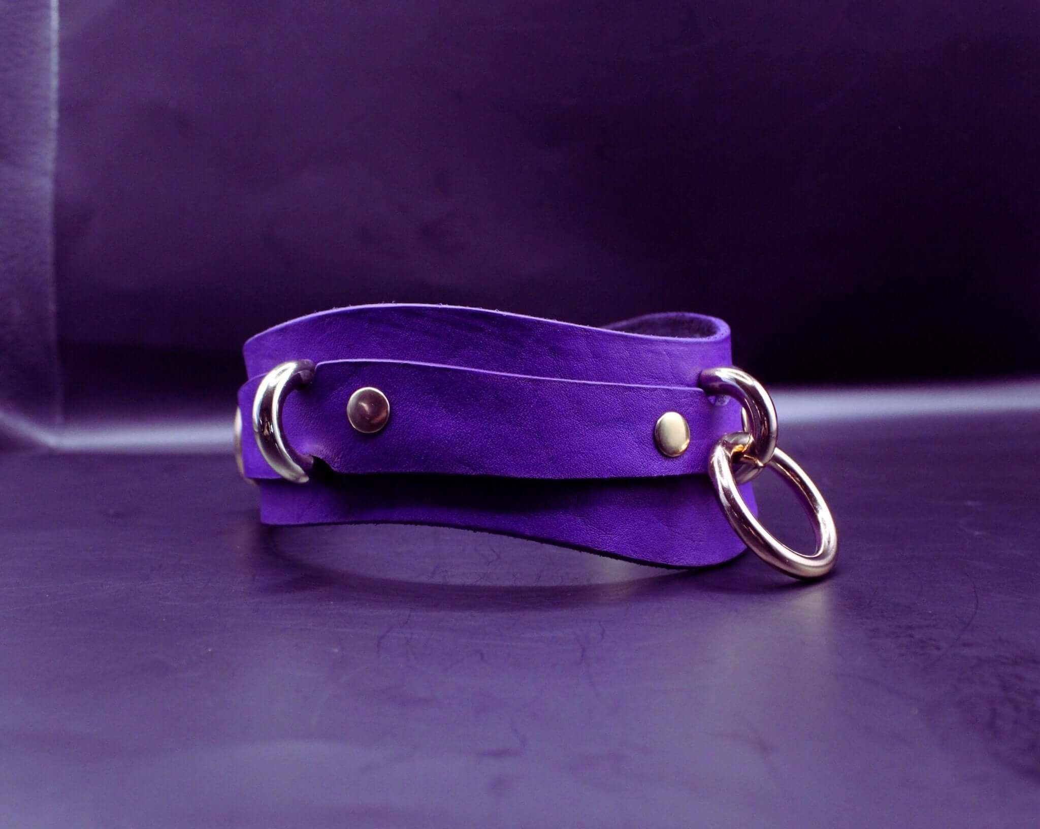 Purple leather posture collar with gold hardware, ideal for BDSM and submissive jewelry enthusiasts.