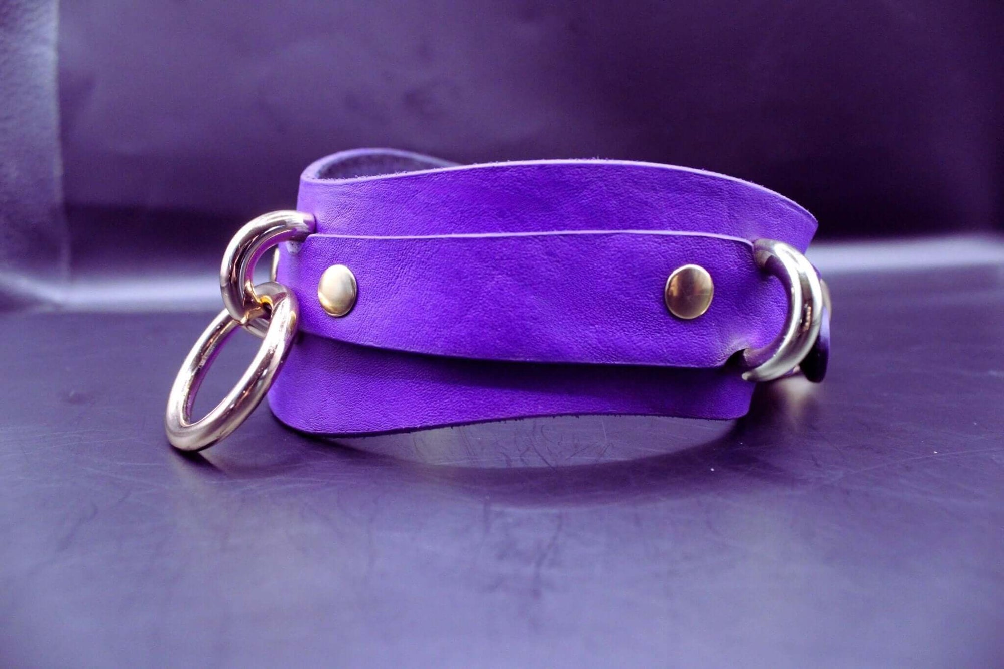 Purple posture collar with gold hardware, perfect for discreet submissive jewelry and BDSM accessories.