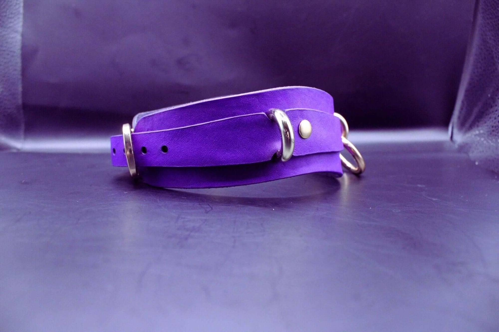 Handcrafted purple posture collar with gold hardware for BDSM, submissive jewelry, and kink lifestyles.