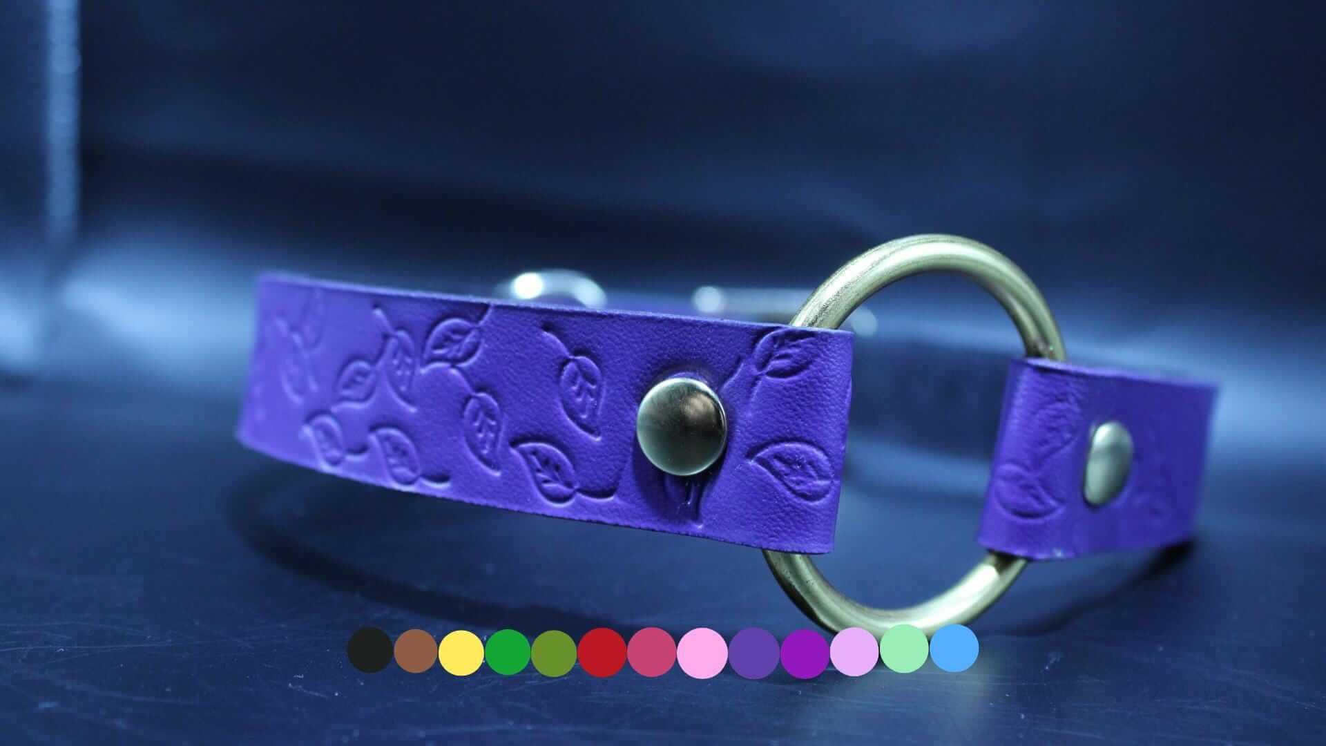 Purple submissive collar with embossed leaf pattern and brass O-ring, ideal for BDSM and petplay enthusiasts.