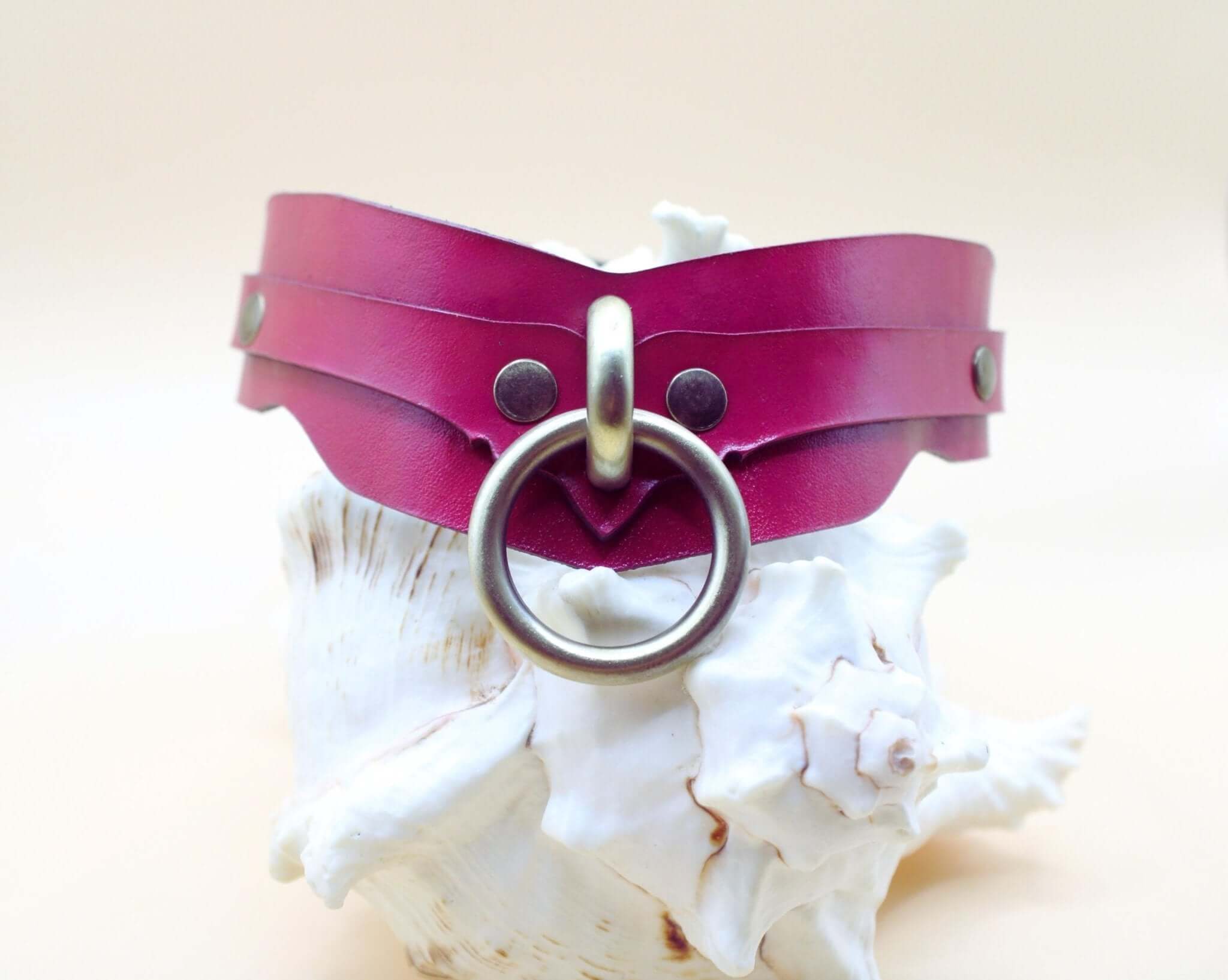 Raspberry leather submissive collar with O-ring, ideal for BDSM, bondage, and dom sub gifts.