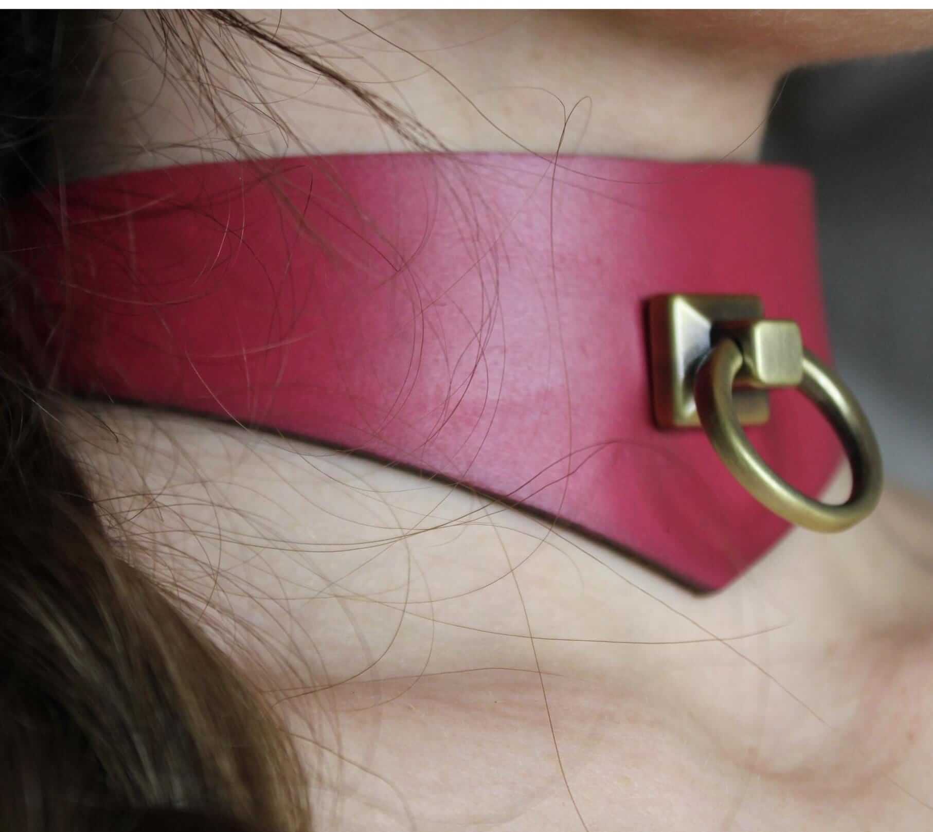Raspberry leather submissive collar with D-ring, perfect for BDSM and sub play, blending beauty and strength.