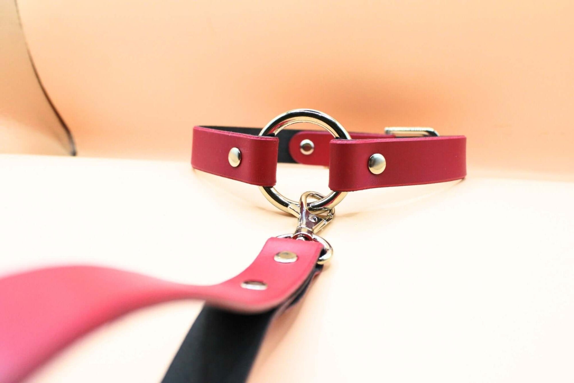 Raspberry leather choker with leash, perfect for submissive jewelry and discreet collar style in bondage gear.