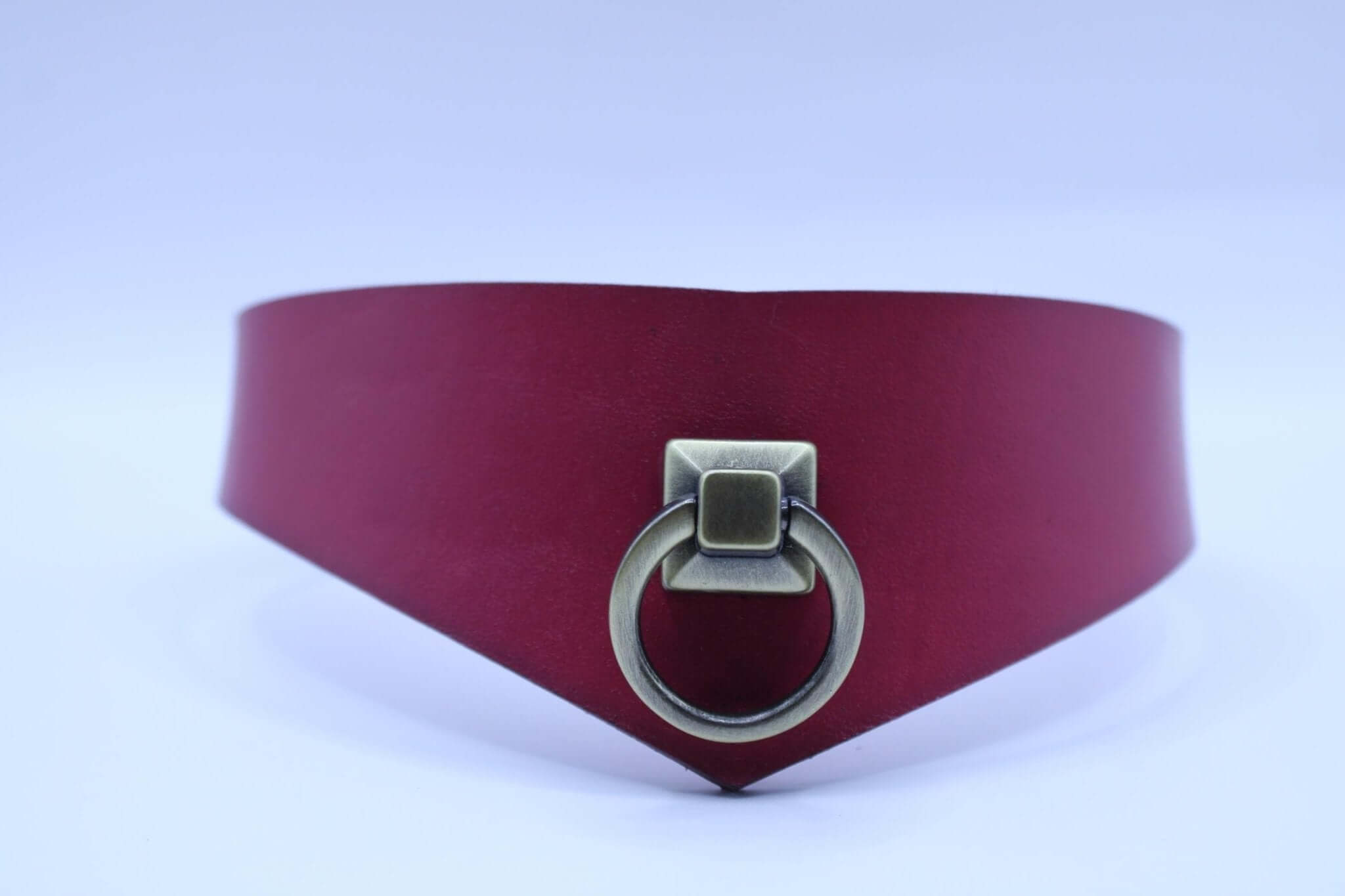 Raspberry leather submissive collar with D-ring, ideal for BDSM and sub play, combining elegance and strength.