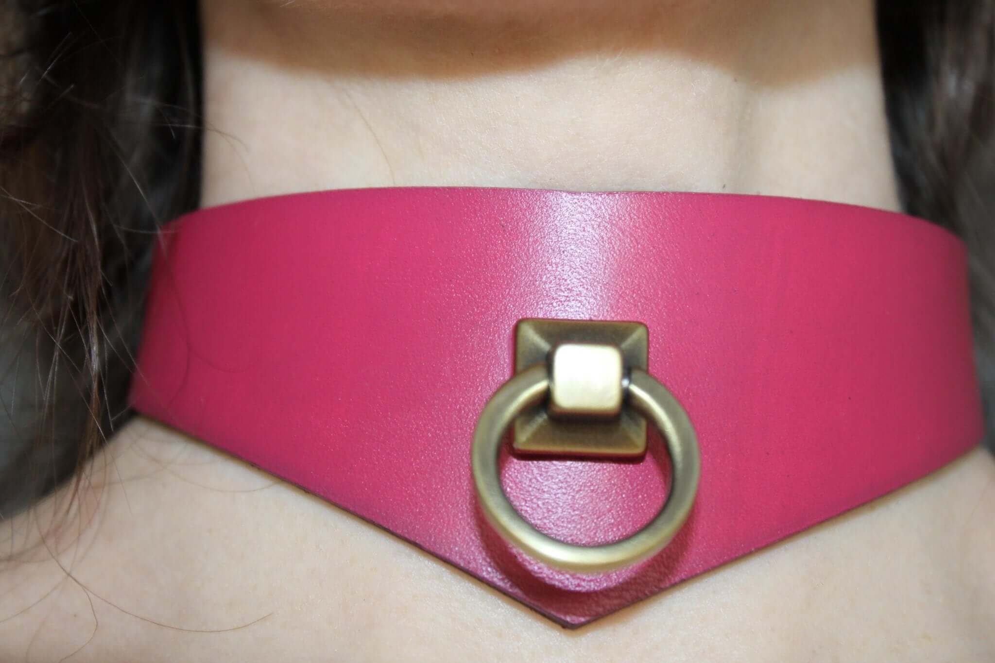 Raspberry leather submissive collar with D-ring, perfect for BDSM play and elegant submission.