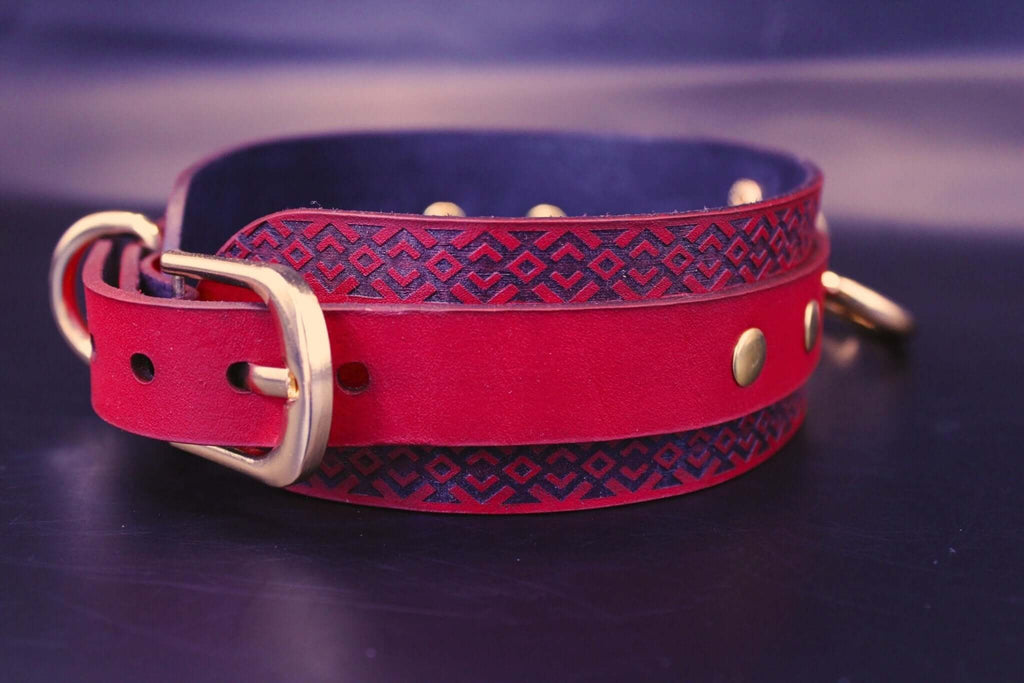 Handcrafted red BDSM collar with blue tribal patterns and gold studs, ideal for submissive jewelry and bondage gear.