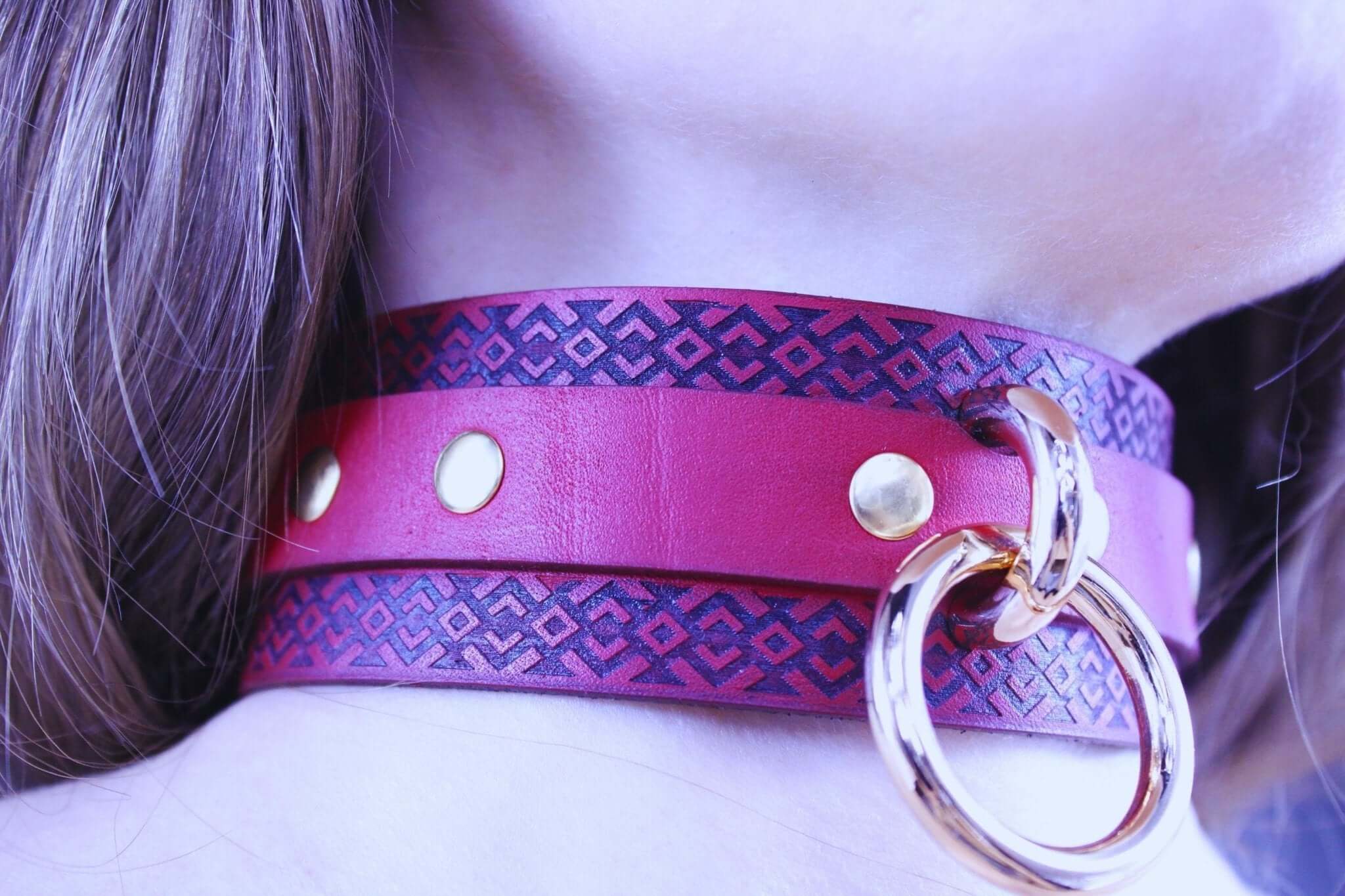 Red BDSM collar with tribal patterns and golden studs, perfect for submissive jewelry and dominance play.