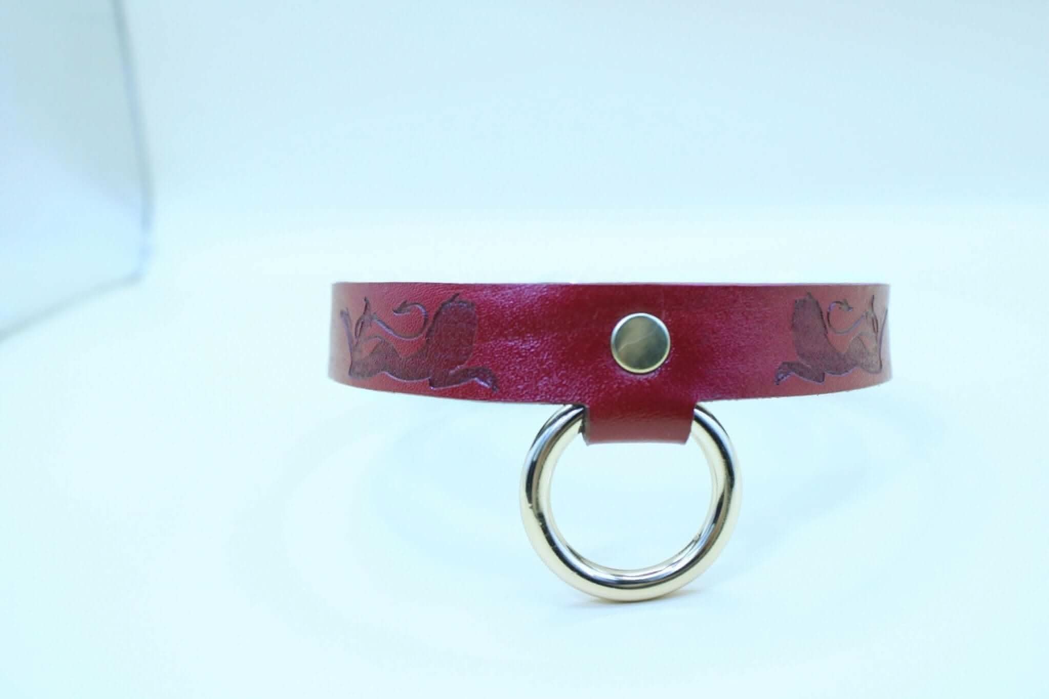Handmade red BDSM collar with O-ring, designed for submissive jewelry and erotic lingerie.