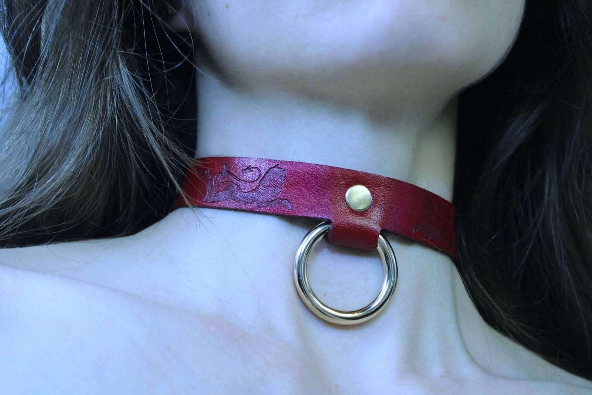 Bold red leather BDSM collar with O-ring, perfect for submissive jewelry and bondage gear, celebrating your fiery side.
