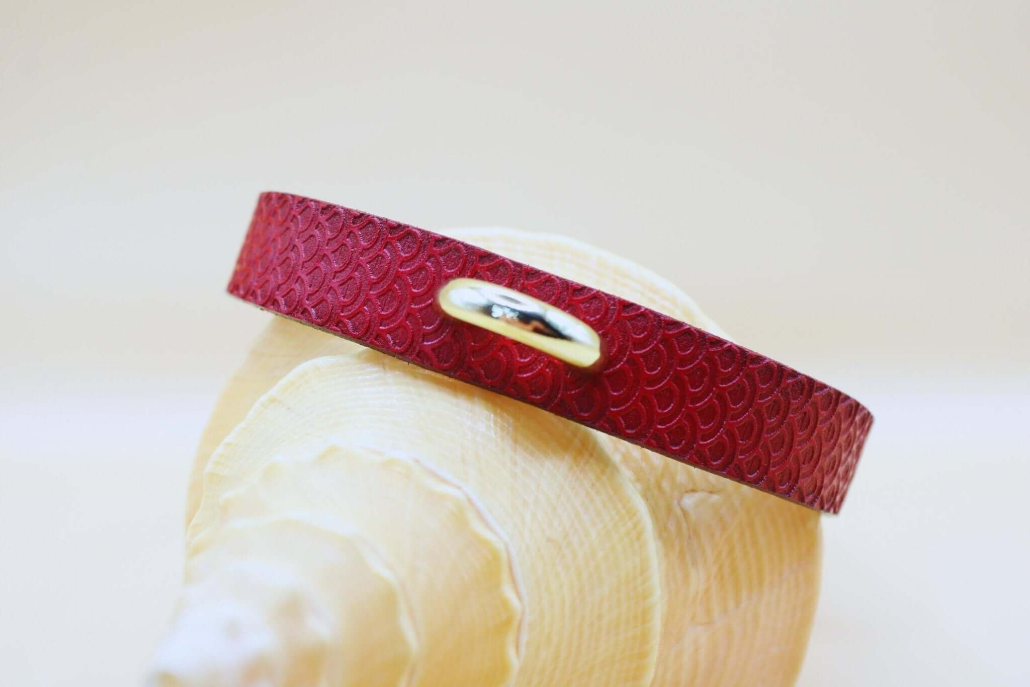 Elegant red leather submissive collar with gold accent, perfect for BDSM and bondage aesthetics.