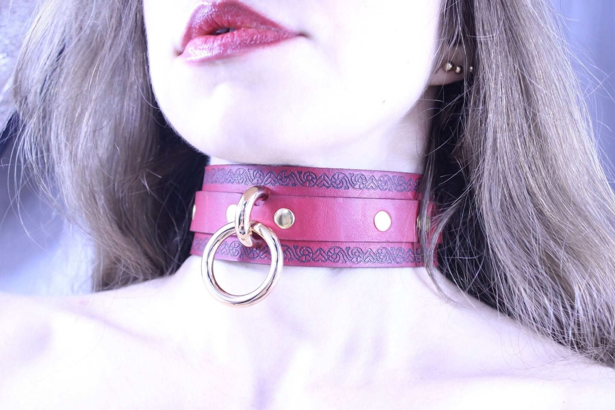 Red leather submissive collar with O-ring, perfect bondage jewelry for power exchange and BDSM enthusiasts.