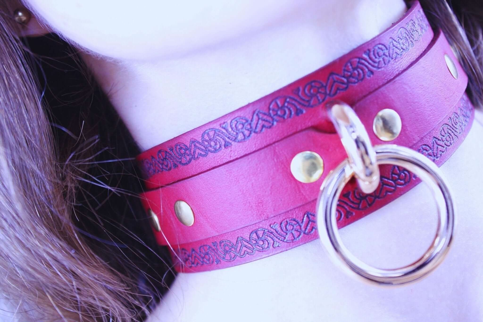 Red bondage collar with O-ring, perfect submissive jewelry and elegant BDSM accessory for power exchange.