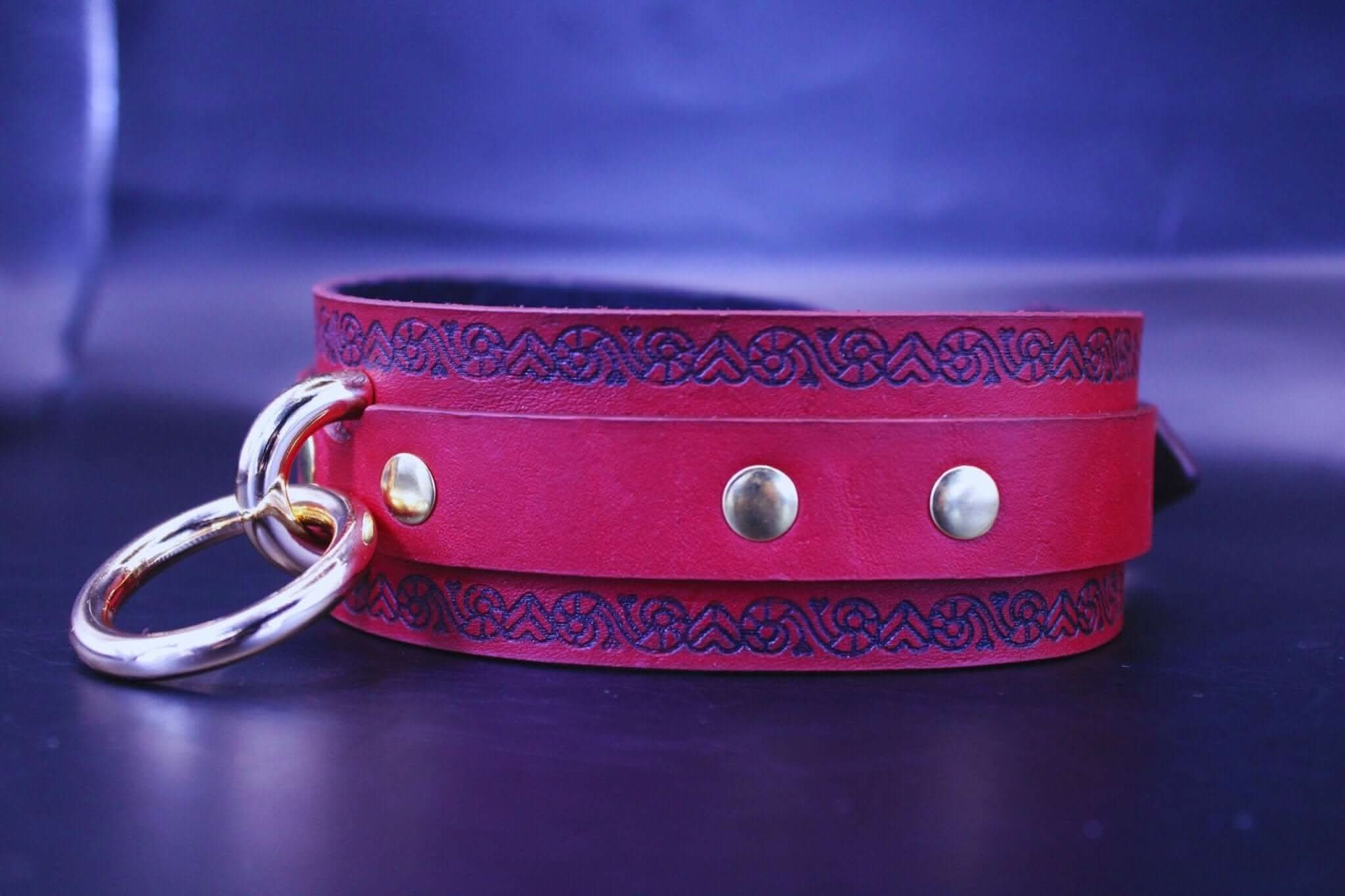 Red BDSM collar with O-ring, perfect for submissive jewelry and power exchange in bondage gear.