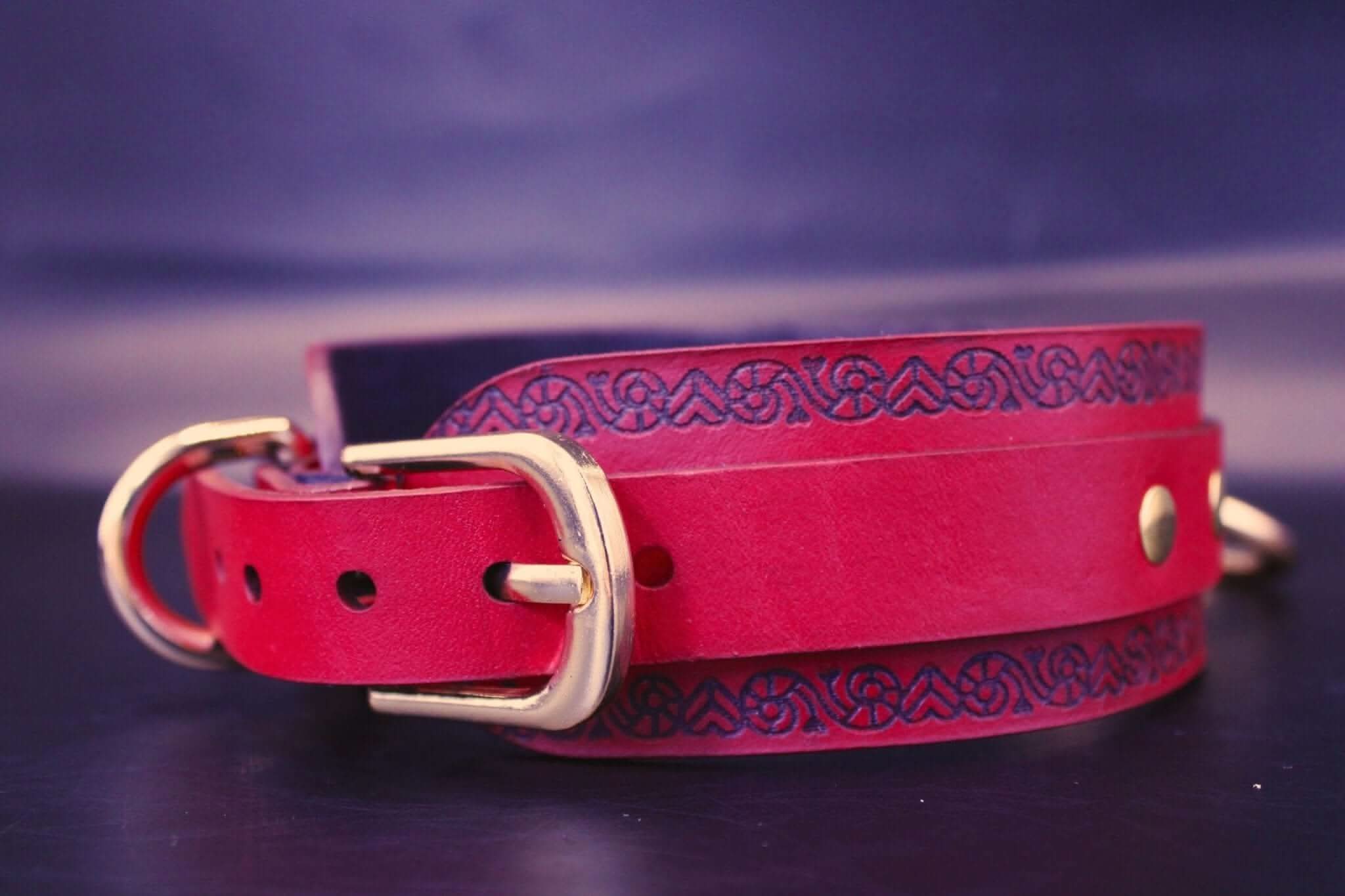 Red BDSM collar with intricate design and golden hardware, perfect for submissive jewelry and bondage gear.
