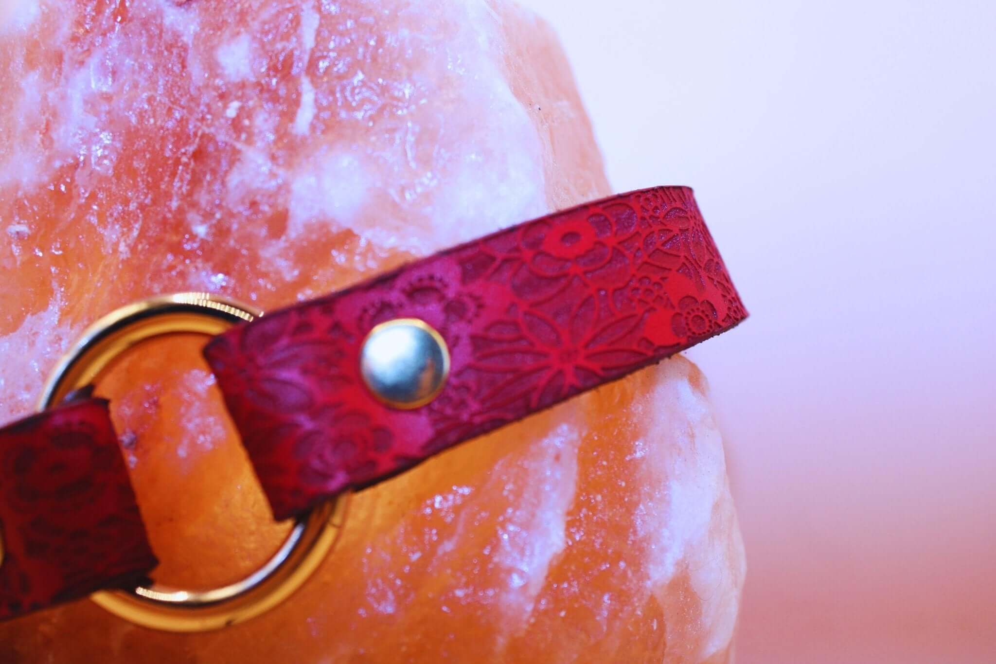 Red floral embossed leather submissive collar with gold O-ring, perfect for BDSM jewelry and sub collar discreet wear.