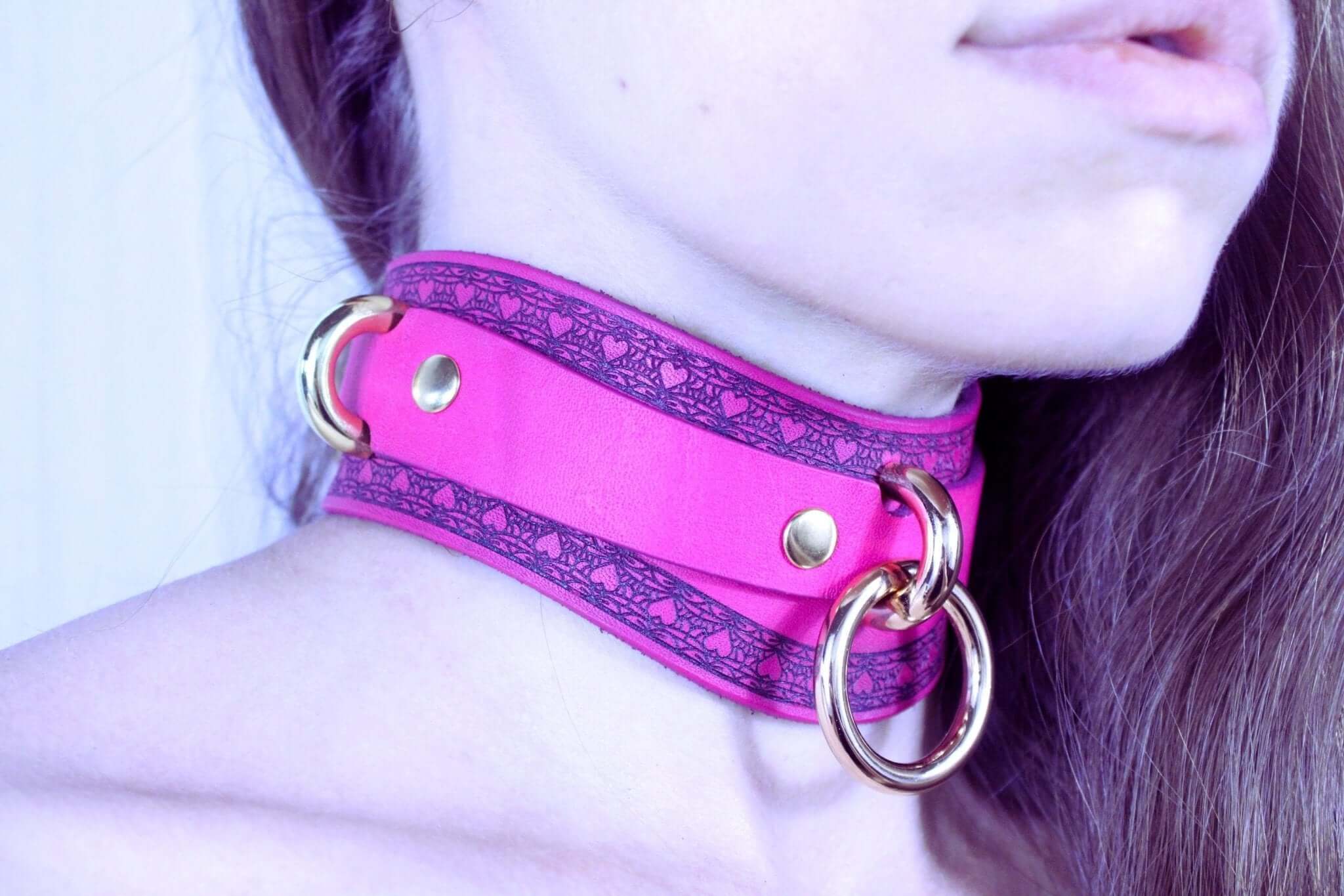 Vibrant pink submissive collar with gold rings, perfect for BDSM style and bondage gear. Ideal for sub collar discreet wear.